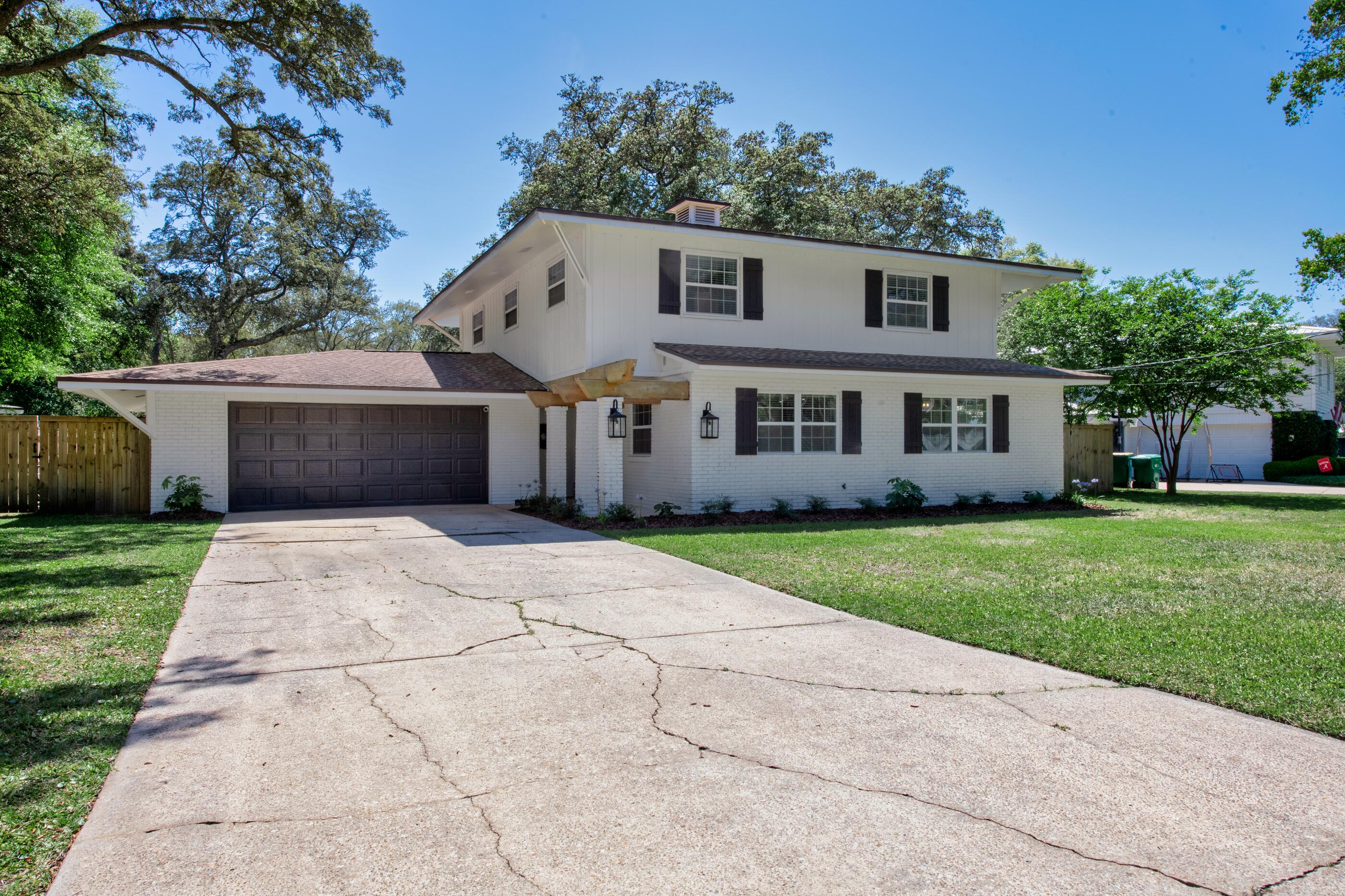 **MULTIPLE OFFERS--Highest/Best due by 8pm 4/17/26** Nestled on a generous .29-acre lot shaded by mature oak trees, this fully renovated Shalimar home offers the perfect mix of comfort, style, & location--plus a rare opportunity to take advantage of a 2.375% assumable VA loan. Originally built in 1976 & thoughtfully updated throughout, the home features a warm, inviting layout with wood laminate & tile flooring, a cozy wood-burning fireplace, & plenty of natural light. The kitchen has been beautifully redesigned with custom wood Shaker cabinetry, soft-close drawers, quartz countertops, subway tile backsplash, a pot filler, & a large island with breakfast bar & built-in microwave drawer--ideal for everyday living and entertaining alike. The spacious primary suite provides a relaxing  retreat, complete with a large walk-in closet & an updated en-suite bath featuring a double vanity & an oversized walk-in tiled shower. Step outside & you'll find your own private backyard escape. The custom pool & spa, added in 2022, are the centerpiece, while the screened-in covered porch offers a comfortable space to relax & enjoy the outdoors year-round. A yard building adds extra storage, & the oversized garage provides plenty of room for vehicles, tools, or hobbies. Located just minutes from Eglin AFB, golf courses, dining, shopping, & medical facilities, this home delivers both convenience & a peaceful setting in one of Shalimar's most desirable areas.