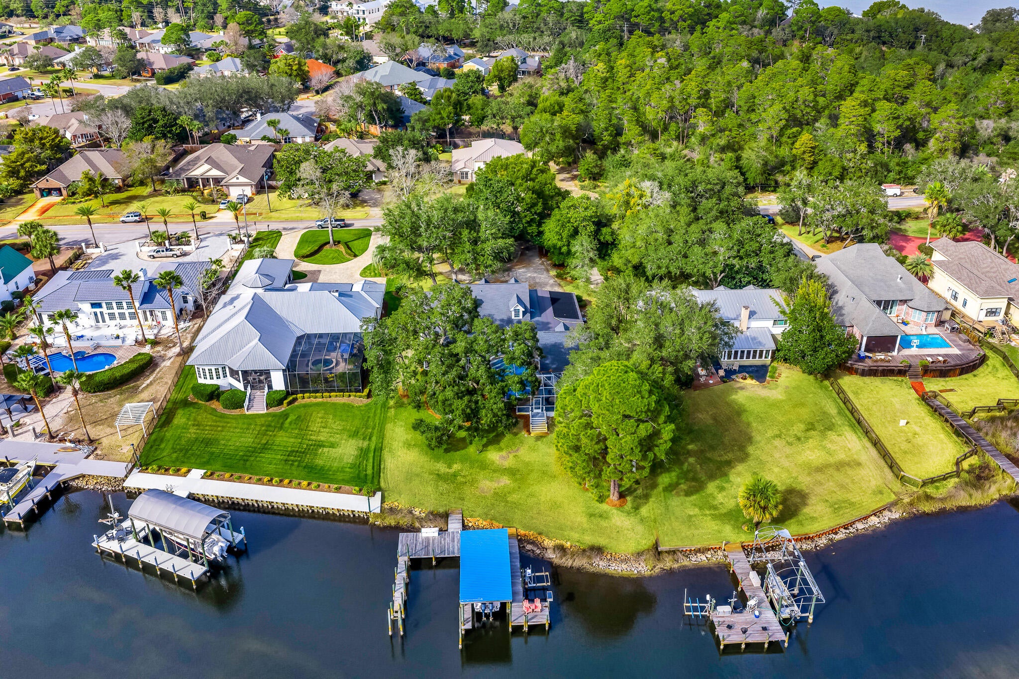 UNDER CONTRACT.  TAKING BACK UP OFFERS. Welcome to your own piece of paradise in the heart of Destin, Florida! This stunning 3-bedroom, 2.5 bath Southern Plantation home with wrap-around porches offers the perfect blend of timeless charm, comfortable living, and an exceptional waterfront lifestyle. Being offered fully furnished and ready for your enjoyment. Step outside to your private pool and enjoy direct deep-water access to the bay, complete with 2 boat slips, a boat and jet ski lift all ideal for boating, fishing, and unforgettable days on the water. Centrally located in Destin, this home puts you just minutes from the area's beautiful beaches, dining, shopping, and everything the Emerald Coast has to offer. Whether you're looking for a full-time residence, vacation getaway, or investment opportunity, this exceptional property delivers the best of coastal Florida living right at your doorstep.