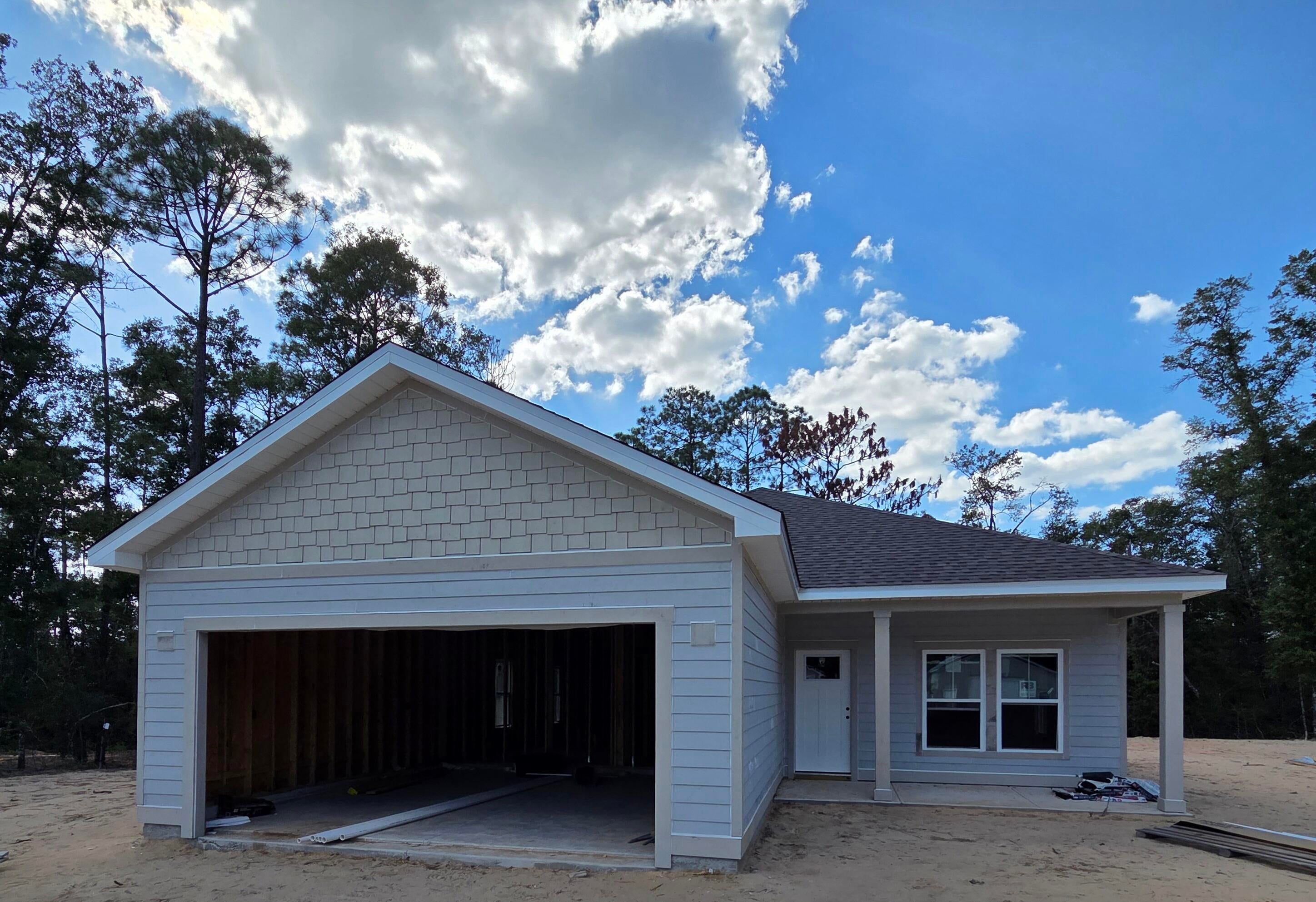 **** Our preferred lender is offering a lender credit towards permanent interest rate buydown for qualified buyer. *** Welcome to your peaceful retreat! This spacious NEW  3-bedroom, 2-bath home offers a total 2,479 sq ft of comfortable living space and is perfectly situated on a beautifully wooded 1.36-acre parcel. Enjoy the perfect blend of privacy and nature with a covered back dock that overlooks serene woods—ideal for relaxing mornings or quiet evenings surrounded by nature. The home features an open floor plan with  generous living and dining areas, and a large kitchen perfect for entertaining or family gatherings. The spacious primary suite includes a full bath, large walk-in closet, and the two additional bedrooms offer plenty of room for guests, a home office, or growing family needs. Construction is underway, but it's not too late to customize to reflect your unique style. This property offers a unique opportunity to live in a nature setting without sacrificing space or comfort. This area is on the rise with major job growth from developments like the Amazon Distribution Facility and the Shoal River Ranch Aerospace Manufacturing Project creating opportunity and boosting local value. Enjoy country living while staying connected just a short drive to Crestview, Fort Walton Beach, Destin, and surrounding areas via Hwy 90 and nearby interstate access. Don't miss this opportunity to own a new construction home by S HS Contracting LLC, in a prime, up-and-coming area. Contact us today for floor plans, estimated completion, and customization options!