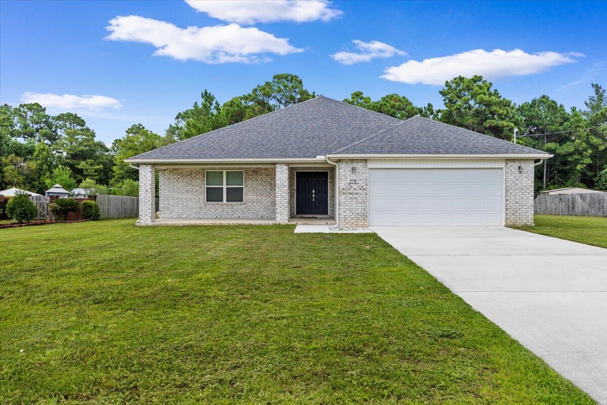 Custom-built and finished with intentional design throughout, this 4 bedroom / 3.5 bath home delivers craftsmanship that is hard to find at any price point in Navarre. Two ensuites give the layout rare flexibility -- whether you need a true primary retreat, a private guest suite, or multi-generational living under one roof. The primary sits off the back of the home with a spa tub, tile shower, double vanity, and custom built-in closet that will ruin you for anything standard.

Set on nearly three-quarters of an acre at the end of a quiet street, the home sits well off the road with ample parking and real privacy. Inside, 2,383 square feet of open-concept living unfolds around a kitchen built for someone who actually cooks. A massive double-door refrigerator, granite counters on every surface, and an island that opens directly to the living room make this the kind of space where people gather. The adjacent dining room has the square footage to match.

Every finish in this home was chosen with purpose. Twenty minutes to Hurlburt Field, ten minutes to Navarre Beach, and tucked into one of Navarre's most private settings. Custom design, room to breathe, and a location that works for any lifestyle.