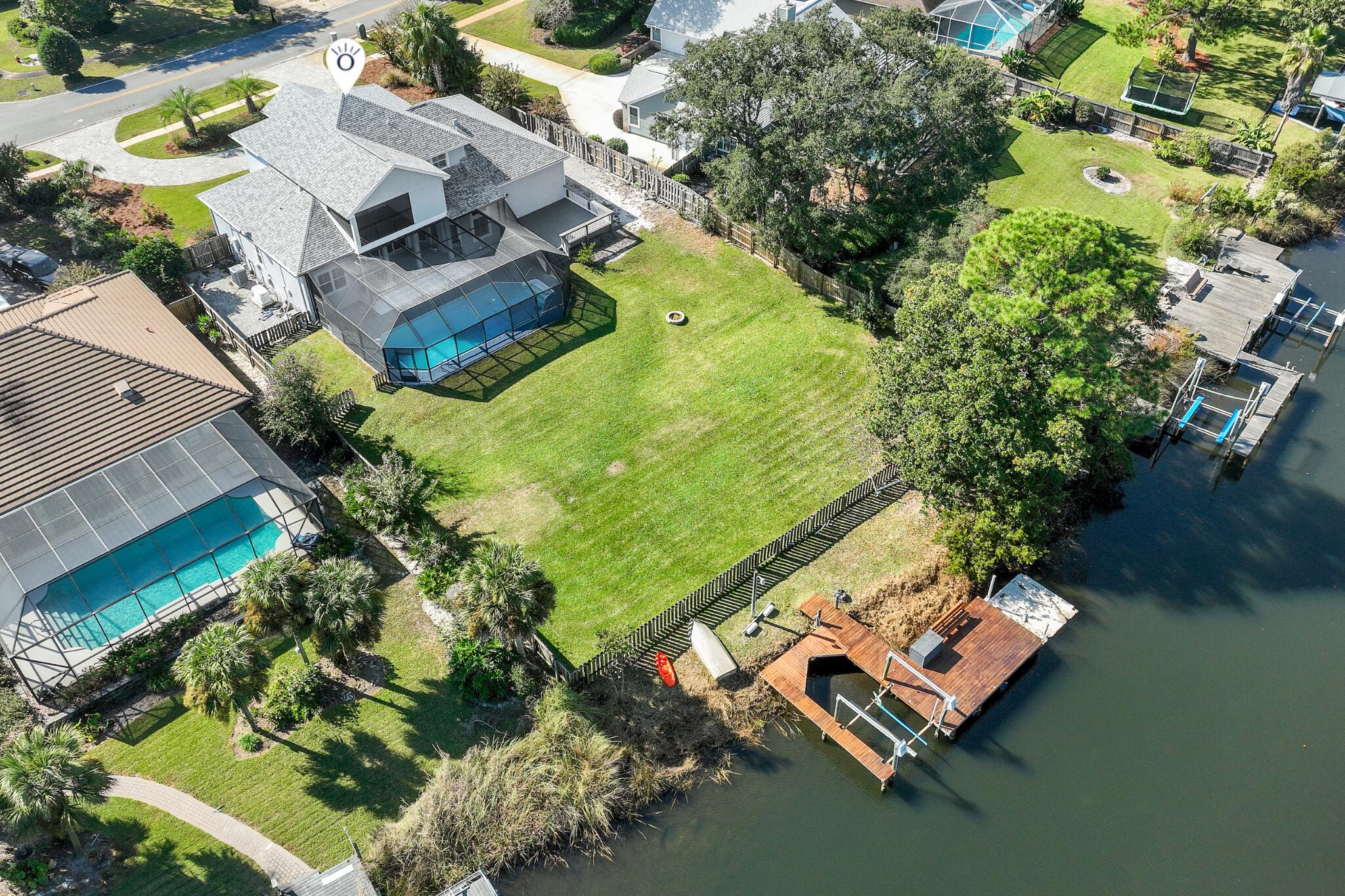 One of the most compelling waterfront values on deep water in all of Destin, and it shows zero signs of compromise. Tucked inside the beloved Indian Bayou neighborhood, this 5-bedroom, 3.5-bath beauty delivers 3,100 square feet of coastal living with a saltwater pool, private dock, and genuine deep-water access, all at a price point that stands out in today's Destin market.
The layout is made for real life. An open kitchen with granite countertops flows into the living and dining areas, so the conversation never stops when you come in from the water. The owner's suite overlooks the bayou for peaceful wake-ups every morning. Two side-by-side guest rooms on the main level can easily function as a secondary primary suite, great for multigenerational families or guests who want their own space. A bonus room adds flexibility for a home office, media room, or bunk room.
Outside is where this home earns its price. A saltwater pool with a new liner, covered patio, and a private dock with boat slip sitting on deep water. You're 15 minutes from the Gulf through East Pass, with Crab Island, Destin Harbor, and world-class fishing right from your backyard. The oversized garage fits an RV, a rare find anywhere on the Emerald Coast. The location is the kind buyers don't find twice. Golf cart to the beach. Minutes to HarborWalk Village, Destin Commons, championship golf, and every restaurant and shop the Destin lifestyle has to offer. Indian Bayou means low HOA fees, an established