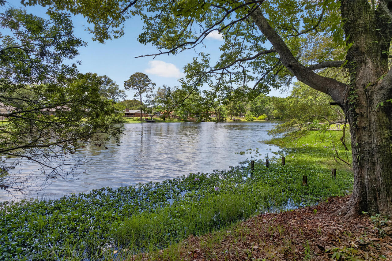 Waterfront Opportunity in the Heart of Niceville! This .16-acre lot in the newly rediscovered Bay Shore Subdivision features a fenced backyard and sits directly on a spring-fed lake, offering a rare opportunity to create your ideal home, vacation retreat, or investment property. Conveniently located near Eglin Air Force Base East Gate, 7th Special Forces Group, and Hurlburt Field, this property places you close to some of the area's largest employers while still being just minutes from the world-famous white sandy beaches and emerald-green waters of the Florida Gulf Coast.

Located near Boggy Bayou and Choctawhatchee Bay, Niceville is known for its strong sense of community, highly regarded schools, waterfront parks, and outdoor recreation. Residents enjoy nearby attractions including Turkey Creek Nature Trail, local parks, boating, kayaking, fishing, and easy access to the shopping, dining, and entertainment of Destin. Destin, often called the ''World's Luckiest Fishing Village,'' is famous for its deep-sea fishing, harbor activities, waterfront dining, and the unforgettable experience of Crab Island -- a popular boating destination with crystal-clear shallow water and a vibrant coastal atmosphere.

The property is also conveniently located near hospitals, grocery stores, Northwest Florida State College, golf courses, marinas, parks, and top-rated recreational areas, making it ideal for both full-time living and long-term investment potential.
The existing mobile home is being sold As-Is and requires significant repairs and updating.  Buyers may choose to remove and replace the mobile home or renovate the current structure. This property may qualify for a VA or FHA NEW construction loan, creating an excellent opportunity for buyers looking to build new in one of Northwest Florida's most desirable and centrally located communities. Bring your vision and take advantage of this waterfront property with endless potential!