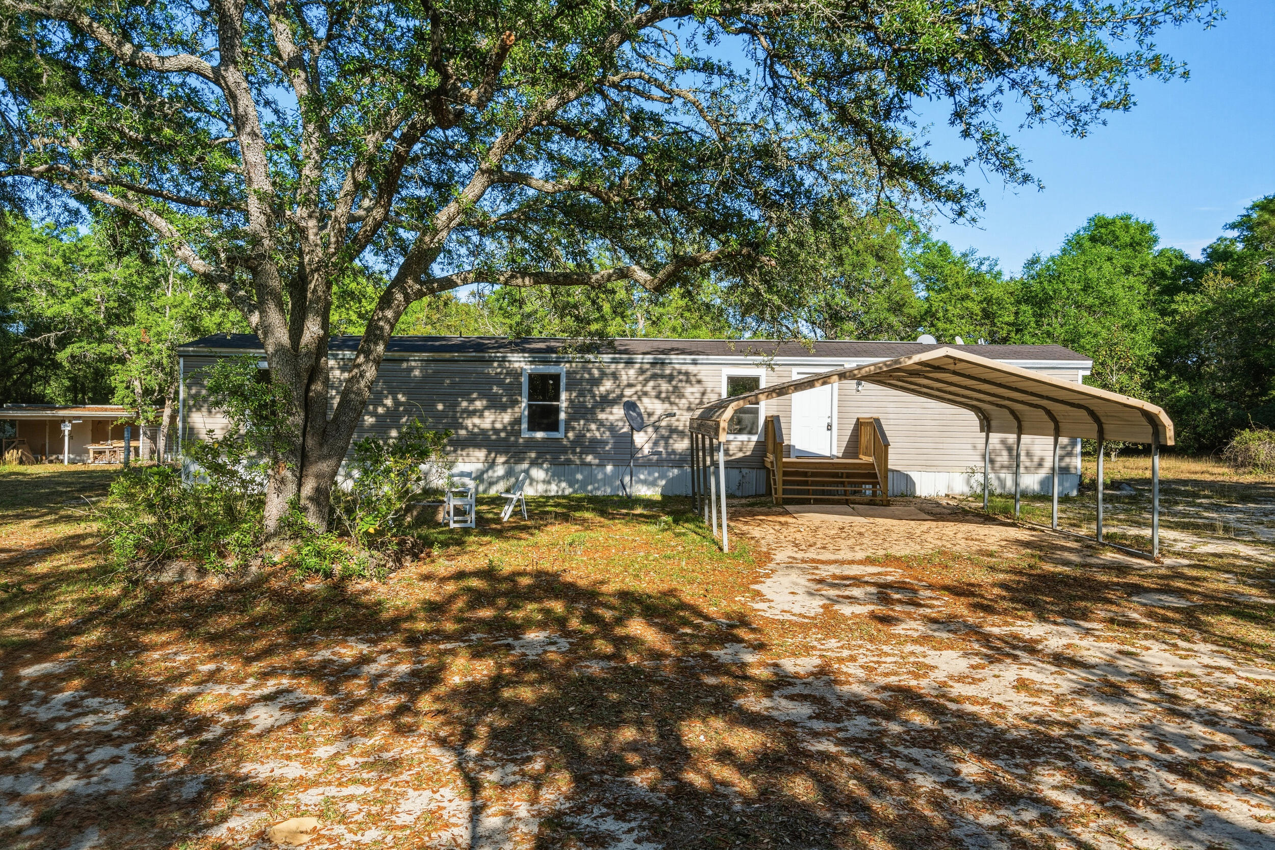 Recently renovated 2-bedroom, 2-bathroom mobile home situated on approximately 1 acre in a quiet and peaceful neighborhood. This property offers a spacious and functional layout with a comfortable living area that flows into the kitchen, making it ideal for everyday living or a relaxed lifestyle. The home features tile bathrooms, adding a clean and updated feel, along with major upgrades including a new AC system and new water heater, providing efficiency and peace of mind for the future owner.  Enjoy the privacy and freedom that comes with a full acre of land, offering plenty of space for outdoor activities, parking, pets, or future. or future additions. With no HOA, you have the flexibility to truly make the property your own. or future additions. Just about 40 minutes from the beach.