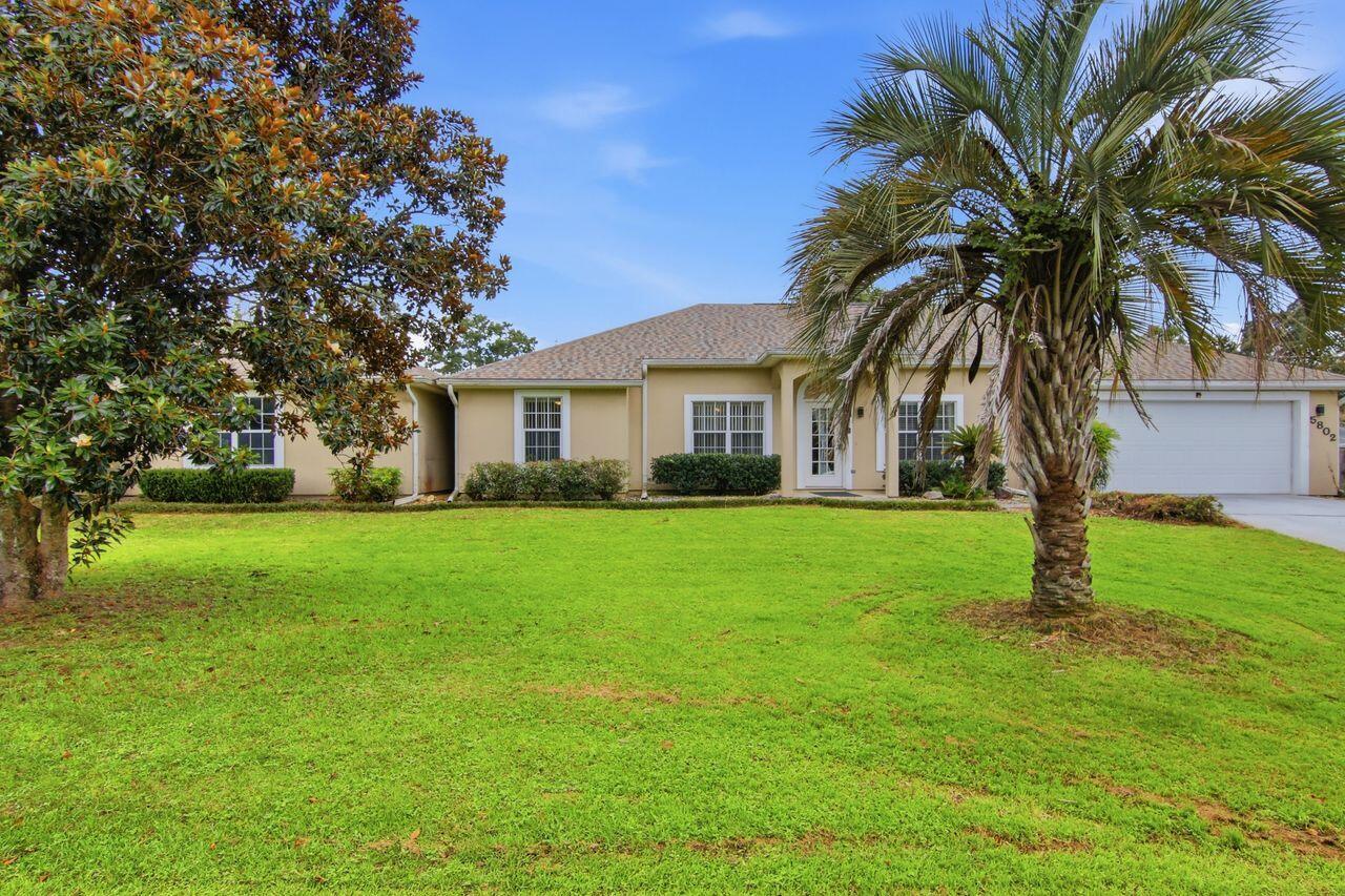 What makes THIS property unique is the Boulevard where it is located, the additional 2 stall detached brick garage, the 1/2 acre of property it sits on and the fact it has NO HOA. Plenty of space for boat and/or RV parking. This is truly an awesome find and is so conveniently located close to schools, shopping and restaurants yet has the feel of seclusion. Enjoy the picturesque yard complete with mature magnolia, crepe myrtle, and walnut trees. All the major components are up to date. Water Heater 2024, Roof 2025, HVAC 2012 and the septic has been inspected and pumped in spring of 2026. This home features 3 bedrooms and 2 bathrooms, large living room with wood burning fireplace, designated dining area, large kitchen offering plenty of cabinets and a pantry. Off of the kitchen is a large laundry room that leads to the attached oversized 2 stall garage. In the dining area are French doors that lead to the enclosed Florida room complete with heat and a/c. From there is a doorway to the enclosed patio area that was designed to be a pool room with drains in the floor that overlooks the back yard with beautiful mature crepe myrtle trees and a palm tree. This property has SO many possibilities.