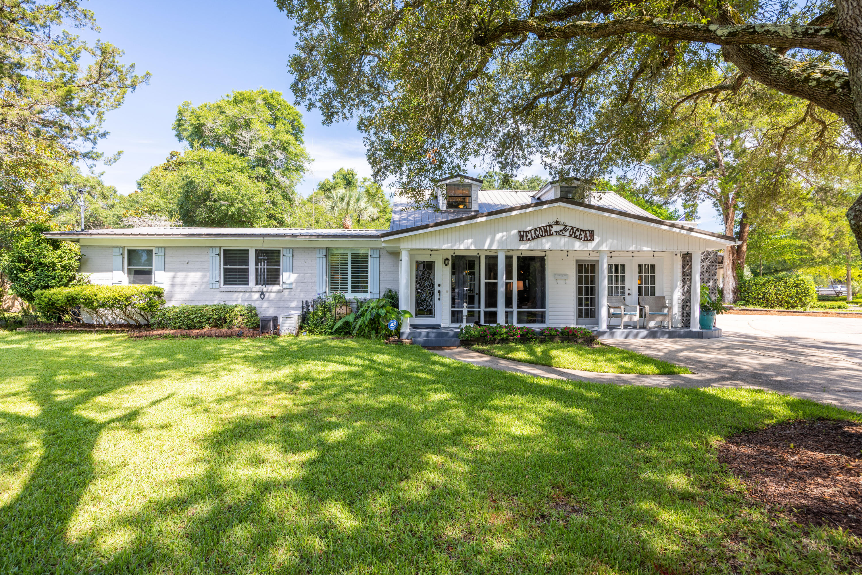 Experience the best of coastal living in this charming 5-bedroom home situated in the quiet, well-established neighborhood of Elliott Point.  With just a short drive to the beach or boat launch, this beautiful home blends the best of an Old Florida lifestyle with modern conveniences, and extensive outdoor living.   The main floor offers 4 bedrooms, 2 baths, kitchen, pantry, laundry, and two spacious living areas along with a large, screened patio just off the back dining room.  While the second floor brings a bonus space, currently used as a bedroom, with a half bath, and an over-sized balcony with peek-a-boo views of Choctawhatchee Bay.  The large backyard and garden areas include a brick grill-fireplace, a hot tub and gazebo, an outdoor shower, a peaceful lanai and fountain area, and a side driveway with two outdoor storage sheds.  The additional side driveway also offers space for an RV or boat. Wake up early and watch the sun rise over the Bay at the Hollywood Blvd Water Access Park only steps from your front door.  In addition, this home is equipped with a whole-house water filtration system, a 50-gallon water tank, and an updated irrigation system with both front and backyard sprinklers. The seller is offering a home warranty and has a transferrable termite bond.  This home benefits from having no HOA, yet is close to the beach, restaurants, great schools, and all the abundance of water activities the Emerald Coast is known for.  Schedule your private showing today!