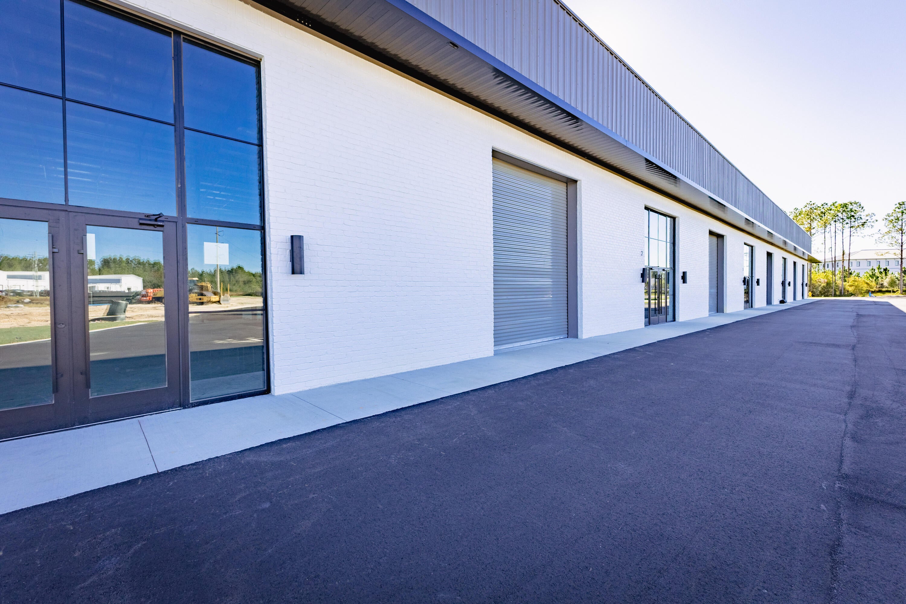 10,300 square feet available for lease in St. Joe's South Walton Commerce Park of the flourishing Santa Rosa Beach, Florida market. This new flex space, warehouse building offers exceptional visibility and favorable ingress/ & egress, as well as an abundance of natural light through it beautiful storefront brick and glass façade; also offers a large industrial roll-up door(s); for a larger commitment of space, a loading ramp and dock will add to convenient logistics and receiving. St. Joe's Watersound Origins and 'Bay-Walton Sector Plan' involves 20,000+ rooftops of residential density and a multitude of other mixed uses in proximity to this new warehouse and flex space. The overall site plan is uploaded to this listing, which includes the last freestanding building, ''Building C', which will contain over 30,000 square feet and a loading dock. Please inquire for further details.