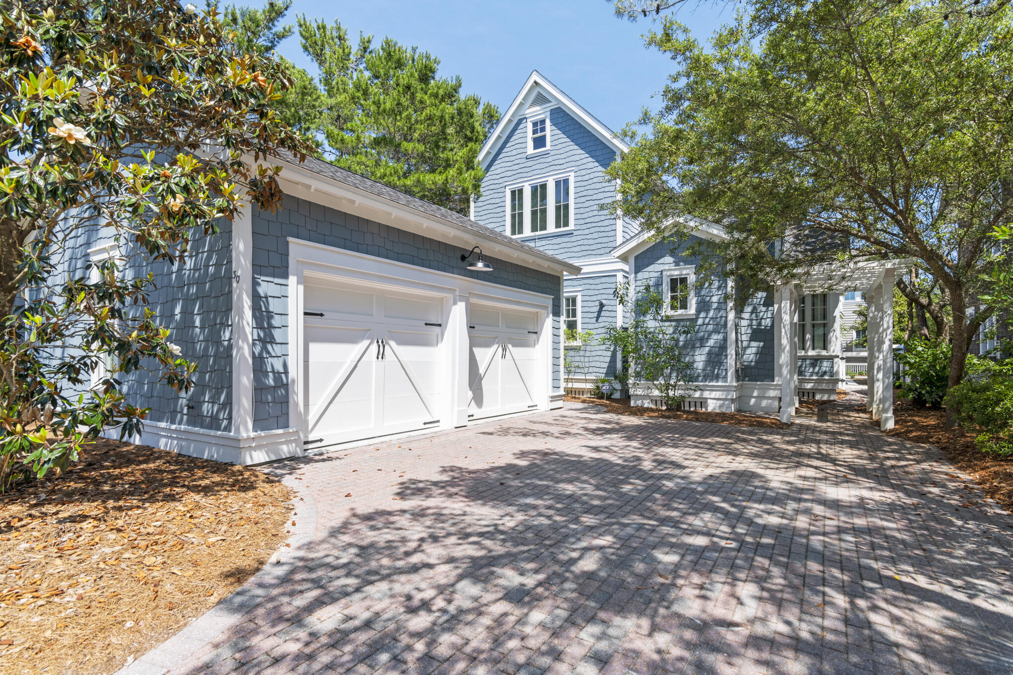 Welcome to 30 North Shingle Lane, a beautifully designed 4-bedroom, 3.5-bathroom home in the heart of WaterSound Beach, featuring a new roof, private pool and packed with style, charm, and modern comforts. Forget cookie-cutter architecture, this Gulf-blue shingle-clad cottage behind a white picket fence has instant curb appeal and classic WaterSound character. A paved driveway leads to a spacious two-car garage and a welcoming footpath to the front porch. Inside, the home features thoughtfully updated décor, stylish lighting, and curated artwork, along with traditional wainscoting, gleaming wood floors, and a cozy fireplace--perfect for family gatherings or relaxed entertaining. he open-concept layout flows seamlessly from the dining area to the gourmet kitchen, equipped with white Shaker-style cabinets, black granite countertops, stainless steel KitchenAid appliances, and a Sub-Zero refrigerator. A central butcher-block island adds both prep space and charm. The spacious first-floor primary suite includes a soaking tub, walk-in shower, and double vanity, while the additional bedrooms upstairs provide comfort and style for guests or family. Screened-in porches on both levels and a landscaped backyard with cozy seating create multiple outdoor living spaces to enjoy the Florida sunshine. The private pool is a standout feature, perfect for cooling off or unwinding after a beach day. This home is ideally located inside the main gates of WaterSound, just a short walk or bike ride to the private beach access, the Dunesider pool, and all of WaterSound's resort-style amenities--including a fitness center with sauna, dog park, children's playground, Puttering Park, Linear Park, and seven miles of scenic boardwalks and walking trails. Don't miss this opportunity to own one of the most charming homes in WaterSound--complete with your own private pool.