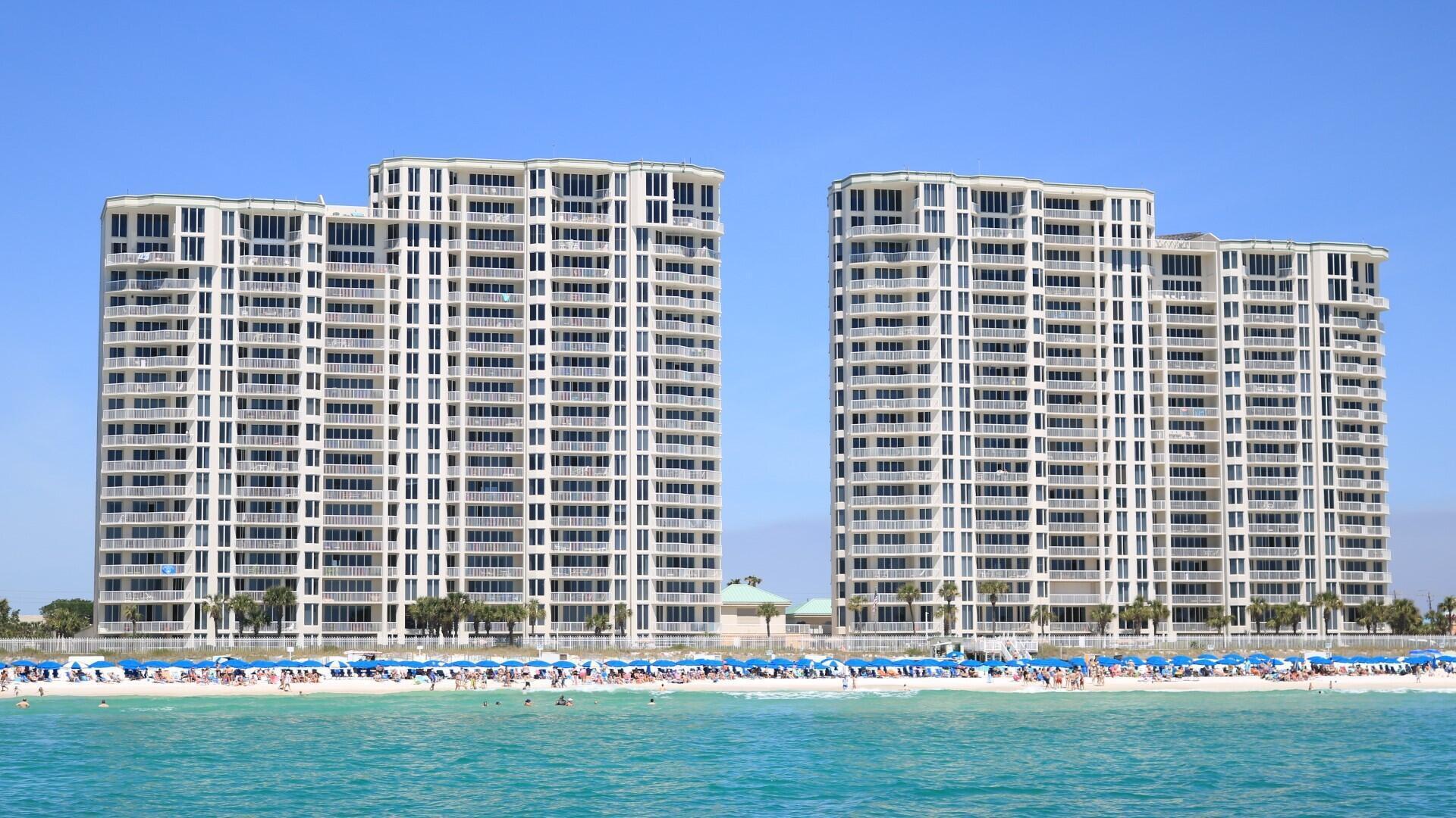 Elevated architectural updates and new beachside food & beverage service makes this Silver Beach Towers condo stand out. From the 11th floor, enjoy sweeping 180 degree Gulf views through floor to ceiling windows spanning the living spaces and both bedrooms making this a proven rental favorite. The split layout enhances privacy, while the Gulf front terrace overlooks two pools and hot tubs and endless views of the beautiful Emeral Coast. A serene primary suite enhances long term appeal for both owners and vacationers. Amenities include tennis courts, covered parking, owner storage, and private beach access. Strong rental performance completes this exceptional unit.