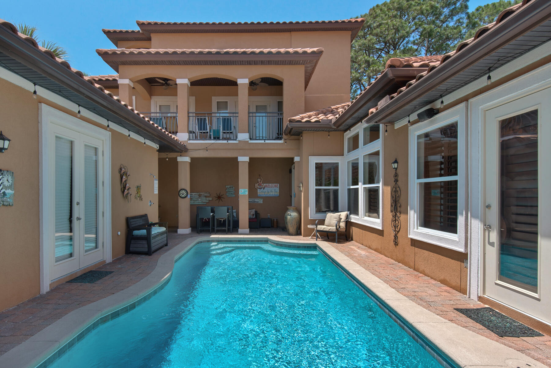 Back on Market at NO FAULT OF SELLER.  Beautiful Mediterranean home located in the sought after community of Destiny East. GOLF CART friendly and less than 1/2 mile from the WHITE SAND BEACH!  This home would make a perfect primary residence, second home or VACATION RENTAL / INVESTMENT opportunity! Rental Projections range between 120K-140K.  Destiny East is a secure, private, gated community with amenities to include (2) community pools, easy beach access, clubhouse, tennis, pickleball and basketball courts, fitness center, theater, playground, lake access, walking trails and an outdoor grilling area. Located only a few minutes away from shopping, entertainment & Gulf-front restaurants.  Situated on a large PRIVATE lot backing up to a nature preserve and positioned at the end of a cul-de-sac with minimal traffic.  Chef's kitchen, open concept living, private courtyard POOL and built in BBQ area with a separate GUEST HOUSE,  Master Suite has a private entrance from the pool area, First level designated office space, a large laundry room. and a large (2) car garage. Second level boasts extra outdoor living space with multiple covered balconies from the bedrooms.  Home features a third floor space perfect for a media room, library, home gym, or craft space.  Amazing views.  One of the most beautiful Mediterranean homes Destiny East has to offer!  Two car garage with GOLF CART included. If you are looking for privacy, amazing amenities and close proximity to the beach, this could be your new dream home!