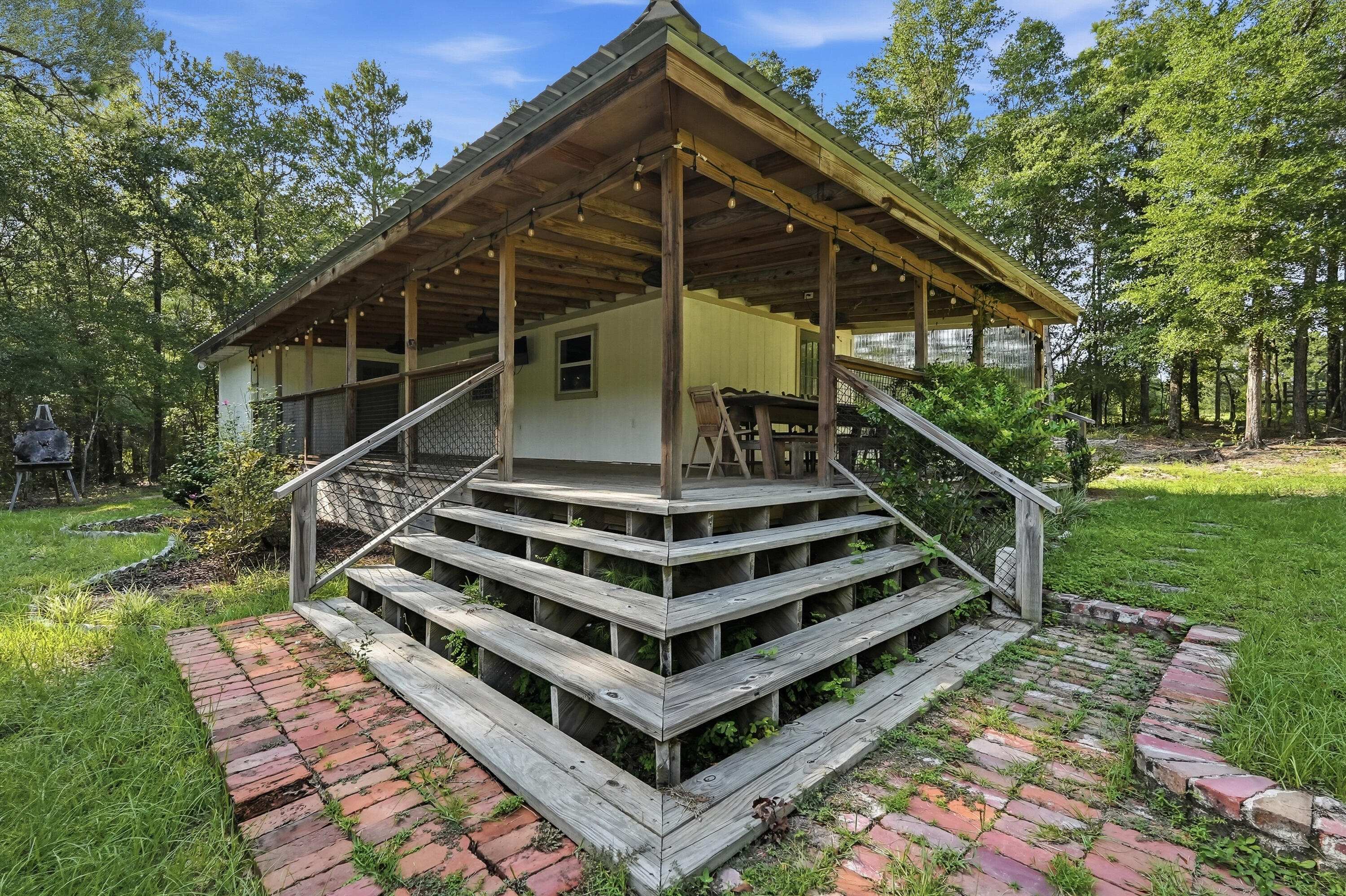 Experience the perfect blend of convenience and peaceful country living in this charming home, tucked away on 3 private acres. This beautiful 1-bedroom, 1-bath home offers comfort, privacy, and everything you need to feel at home.

Relax and unwind on the spacious covered wraparound porch, perfect for enjoying your morning coffee or taking in the peaceful surroundings. Whether you're looking for a quiet retreat or a place with easy access to nearby amenities, this property offers the best of both worlds.

Don't miss this unique opportunity to enjoy country living with modern convenience. Schedule your showing today!