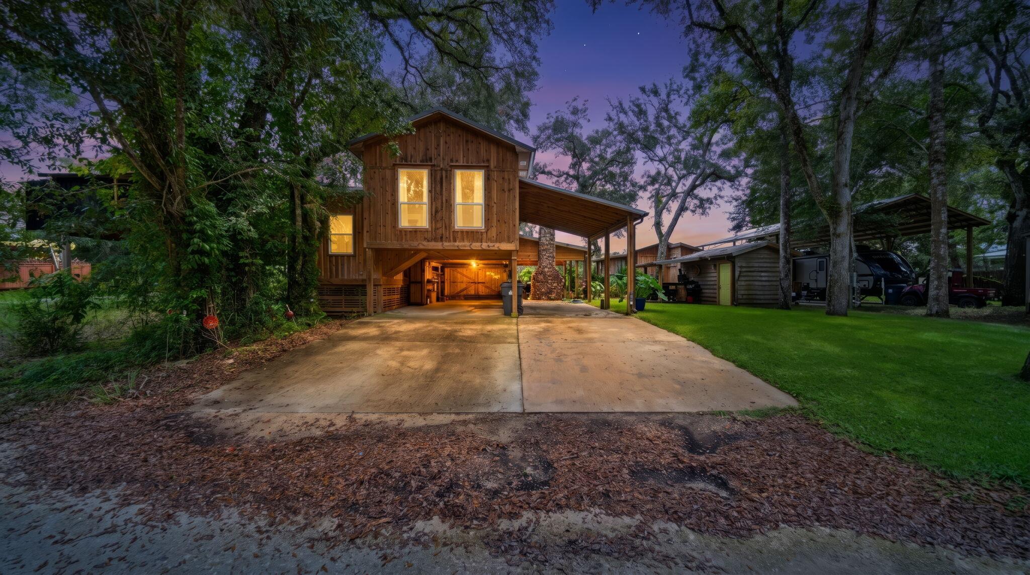 Riverfront retreat on the Choctawhatchee, Steps from Cowford Landing.  Breath deep and slow down at this rare riverfront escape with approx. 180* view and +/- 30ft to the river's edge.  The elevated main home on pilings, pairs coastal-camp charm with practical living, while a separate studio cabin with full bath make hosting effortless.  Enjoy 2 screened-in patio enclosure that invites morning coffee, evening stories, and year-round breezes.  Outside gather under the stars around the outdoor fireplace/ entertainment area.  Store gear in the side Shed, tuck vehicles under the covered parking pad, and bring the toys.  there's a sheltered concrete pad sized for a boat or RV.  Fishermen and paddlers will love the setting on the Choctawhatchee River that leads to the Choctawhatchee Bay.  The Convenience of Cowford Landin's public boat ramp (600 Ft. away).  Be on the water in minutes.   Dreaming Bigger?!? The site offers room to add a dock and steps for a true fishing camp retreat (Buyt to verify all permitting, setbacks, and riparian rights)