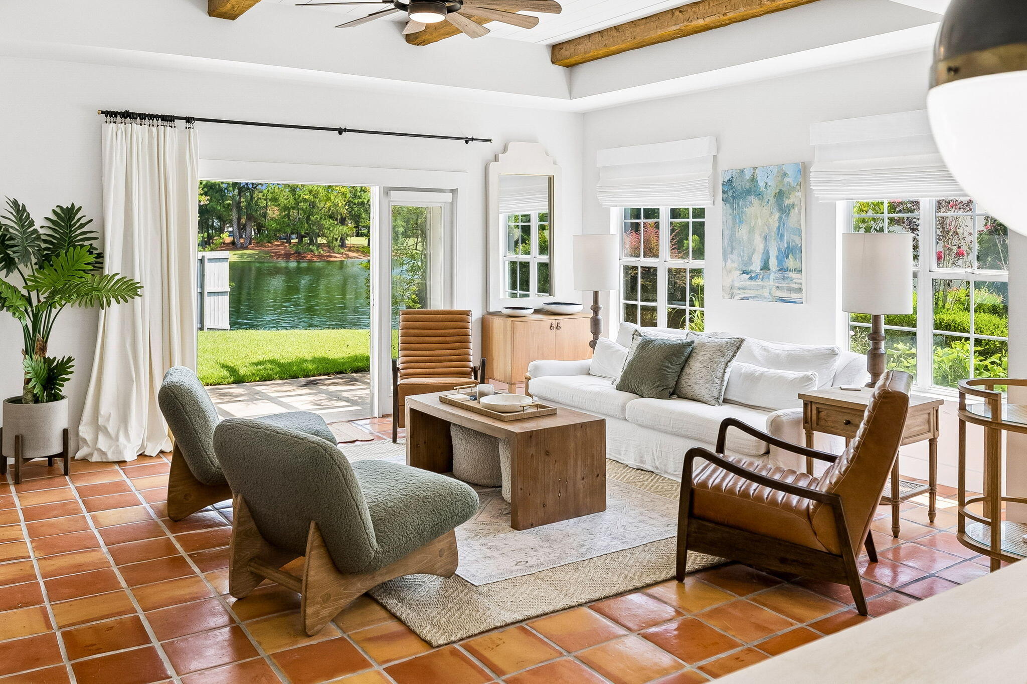 Perched on the original corner lot in Legend Creek, a non-short-term-rental enclave within Sandestin Golf and Beach Resort, this three-bedroom, two-bath home offers just under 1,500 square feet of thoughtfully renovated single-story living. A private, gated courtyard framed with crepe myrtles and mature oaks leads into the white stucco, Mediterranean-inspired home.

As you enter the main entryway, Saltillo tile flows throughout the home, creating an immediate sense of warmth and calm. The first bedroom, located just off the entryway and currently set up as both a bedroom and office, creates an ideal multi-functional space, while down the hall, the second bedroom overlooks the front garden and offers an inviting guest retreat.

Entering the open-concept living, dining, and kitchen space beneath a raised shiplap ceiling crossed with rustic wood beams, you're immediately greeted by warm natural light spilling in from the surrounding windows, which overlook the lush side garden, backyard, and peaceful pond. The kitchen has been tastefully updated with butcher-block countertops, a handmade subway tile backsplash, and stainless steel appliances, including a Samsung Bespoke 4-Door French Door refrigerator. From the kitchen, a sun-filled dining area and living room look out over the private side garden and a beautiful patio, complemented by serene pond views. The primary suite offers a private retreat with direct patio access and an en-suite spa-style bath featuring a freestanding soaking tub beneath a statement chandelier, a glass walk-in shower, a walk-in closet, and a double vanity. The secondary bath carries the same elevated finishes, with a dual vanity, black granite counters, and rattan-framed mirrors.

Out back, a pergola wrapped in flowering Peggy Martin roses helps shade the patio, perfectly positioned to take in the pond and its fountain. As you walk around the winding side walk path, a natural gas equipped grill is located just off the dining room and kitchen providing an ideal outdoor space to cook and relax.

All while just a walk or golf cart ride from the Village of Baytowne Wharf, this home includes access to the many amenities of Sandestin Golf and Beach Resort including access to multiple championship golf courses, private beach, marina, tennis, and resort-style pools.