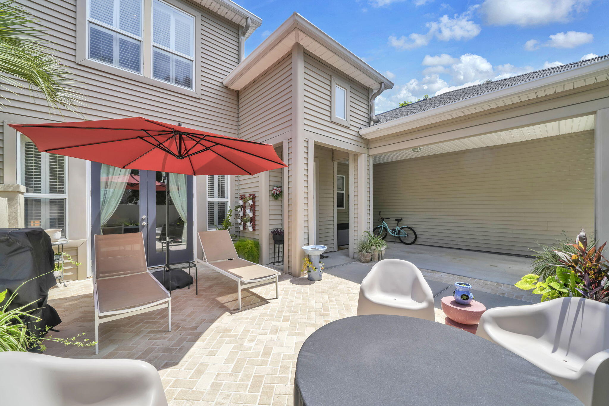 Welcome to 65 Courtyard Circle, where coastal living meets comfort and convenience! This beautifully upgraded home is being sold mostly furnished (with a list of exclusions) but also includes extra 'toys' to fully equip you for 30A's ultimate beach lifestyle! Included in the purchase are a golf cart, Vespa scooter, two E-bikes, a kayak, and an inflatable BOTE paddleboard. Recent upgrades that set this home apart: New AC and mini split upstairs; New flooring; upgraded front and French doors; new custom pavers; attic flooring for storage. The washer and dryer are also included in the sale. Featuring a solid privacy wall enclosing both the front and back patios, this property offers an exceptional outdoor retreat, complete with a hot tub, Cold plunge, and an indoor infrared light sauna. Inside, you'll find custom-built cabinetry and additional countertop space in the dining area (a sought-after upgrade), along with an electric fireplace that creates a warm and inviting living space. Located in the private, gated Courtyards at Santa Rosa Beach, this 44-home community offers a peaceful, residential atmosphere with NO SHORT-TERM RENTALS allowed. Residents enjoy a resort-style pool and cabana, among beautifully maintained grounds. Just a short golf cart ride away from nine public beach accesses, including two that feature free parking, restrooms, and seasonal lifeguards. The Santa Rosa Golf Club is less than 1/4 mile away, and notable dining and entertainment venues like Stinky's Fish Camp, Shunk Gulley Oyster Bar, the Growler Garage, and the Vue on 30A, are within just a few minutes via golf cart. This move-in-ready gem offers the best of beach living just minutes from the sugar-white sands, dining, shopping, and entertainment of the "West End" of 30A.