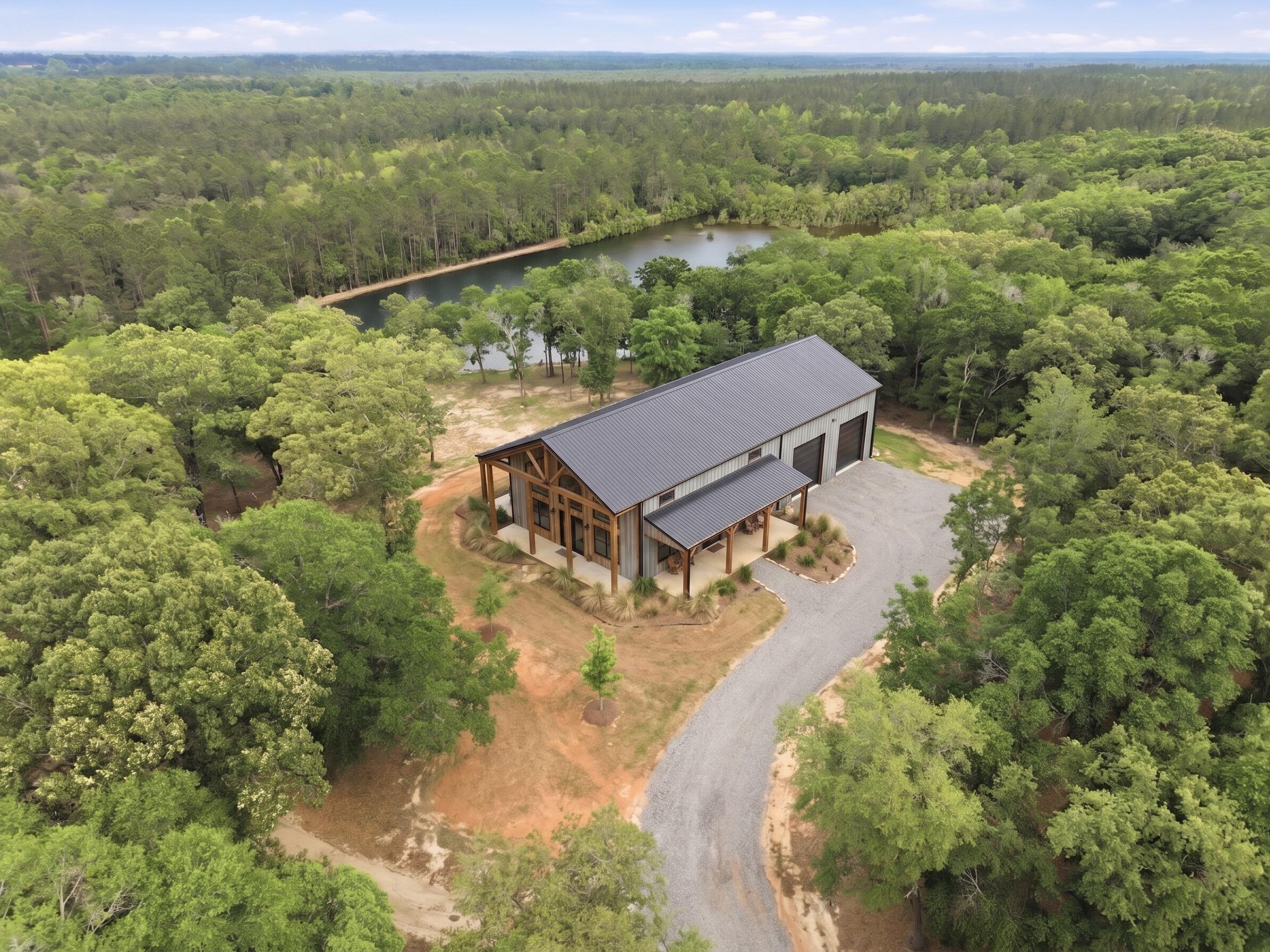 Discover the peace and freedom of country living on 80 stunning acres in North Walton County, just 40 minutes from the world-famous beaches of 30A. Tucked away in a quiet, natural setting, this one-of-a-kind property offers the perfect opportunity to create the lifestyle you've always imagined.  
This is 4 separate parcels being sold as one single property.  The East side of Wilkerson Road is the portion of the property with the 5 acre lake and which shows the rendering of a potential home site.  This is 3 conjoined parcels that are right under 54 acres.  The West side is where the current 2 bedroom homes currently stands and is nearly 27 acres.
The land features three beautiful spring-fed ponds, including a stocked 5-acre pond ideal for fishing and relaxing by the water. A charming renovated 2BR/1BA country cottage and large garage/shop provide a comfortable base while leaving endless possibilities for expansion or customization.
Whether you envision an equestrian estate, private hunting retreat, family homestead, recreational getaway, or long-term investment, 261 Wilkerson Road gives you the space and freedom to make it your own. Ride horses through open land, enjoy ATV trails, spend quiet mornings fishing, or simply take in the breathtaking natural beauty and privacy that surround you. Opportunities like this are rare - a property where you can truly slow down, spread out, and build the life you want.