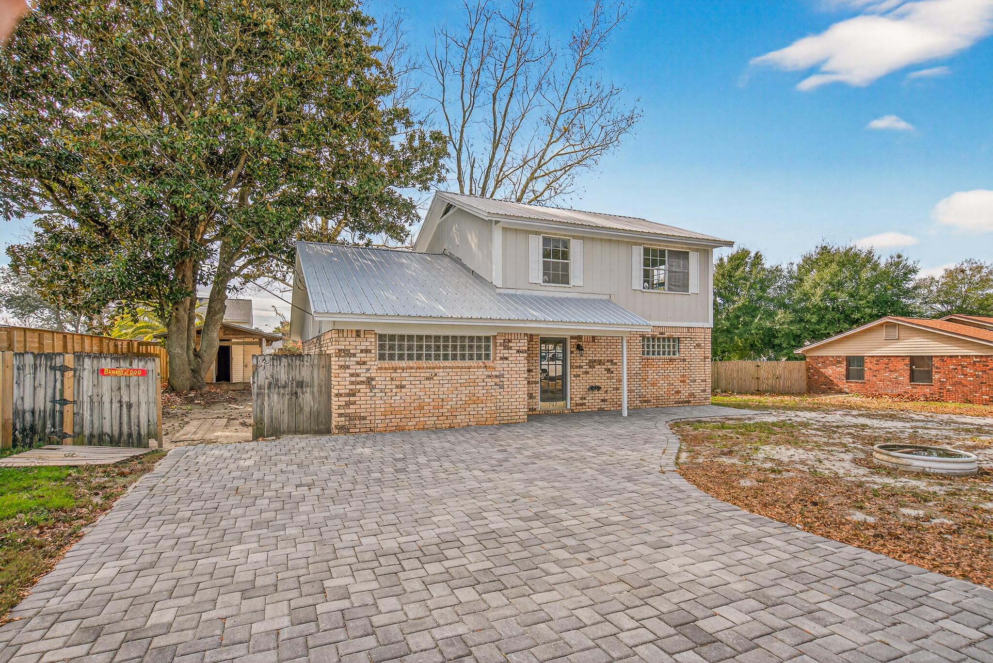 Welcome to this charming two-story home located in the vibrant city of Destin, FL. This property boasts three spacious bedrooms and 1.5 bathrooms, providing ample space for comfortable living. The kitchen is equipped with practical laminate countertops and washer/dryer hook-ups, offering convenience for your everyday needs. The exterior of the house is adorned with sturdy brick siding and a metal roof. The paved driveway adds to the overall appeal and functionality of the property. This property is distressed and in need of updates and some TLC, but at an affordable price, this adorable property would make an excellent investment property or first-time home. Vacant and easy to show.