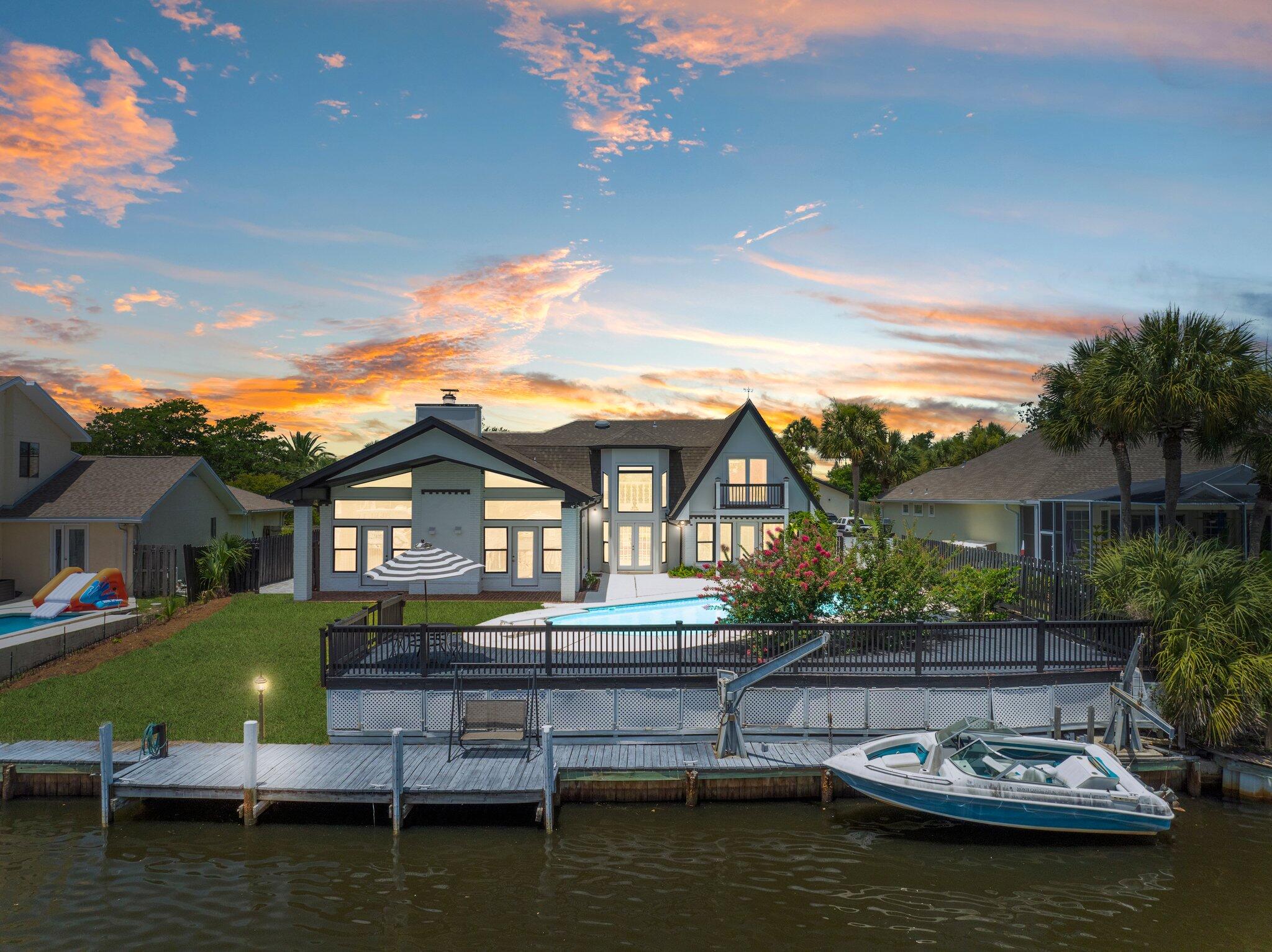 Stunning Waterfront home in Bay Point - A Boater's Dream! This breathtaking 3189 sq ft waterfront home in the prestigious Bay Point community, offering 4 spacious bedrooms, 3 beautifully updated bathrooms, and a flexible bonus/game room that opens to a private balcony with panoramic water views. Perfectly situated at a wide intersection of the canal with approximately 78 feet of water frontage, this home is ideal for large vessels and boating enthusiasts. Enjoy direct water access, a small boat lift, and a paver side yard perfect for additional storage. Inside, you'll find a grand open-concept living space with vaulted ceilings, floor-to-ceiling custom windows, and a cozy fireplace, all designed to highlight the one-of-a-kind views and flood the home with natural light. The renovated kitchen is a chef's delight, featuring quartz countertops, stainless steel appliances, and a large breakfast bar perfect for entertaining. The luxurious primary suite offers serene water views, a walk-in closet, and an updated ensuite bathroom with a double vanity, walk-in shower, and soaking tub. With two bedrooms upstairs and two downstairs, this layout provides comfort and privacy for the entire family. Step outside to your private pool, expansive deck, and beautifully landscaped surroundings. Additional features include a U-shaped driveway, updated flooring throughout, and a large attic space for extra storage. When you purchase in Bay Point you're not just purchasing a waterfront home. Bay Point is known for its pro golf course the Nicolas course, its newly renovated Marina, annual events such as Bill Fish and so much more. Whether you're seeking a peaceful getaway or an entertainer's paradise, this waterfront gem delivers coastal living at its finest.