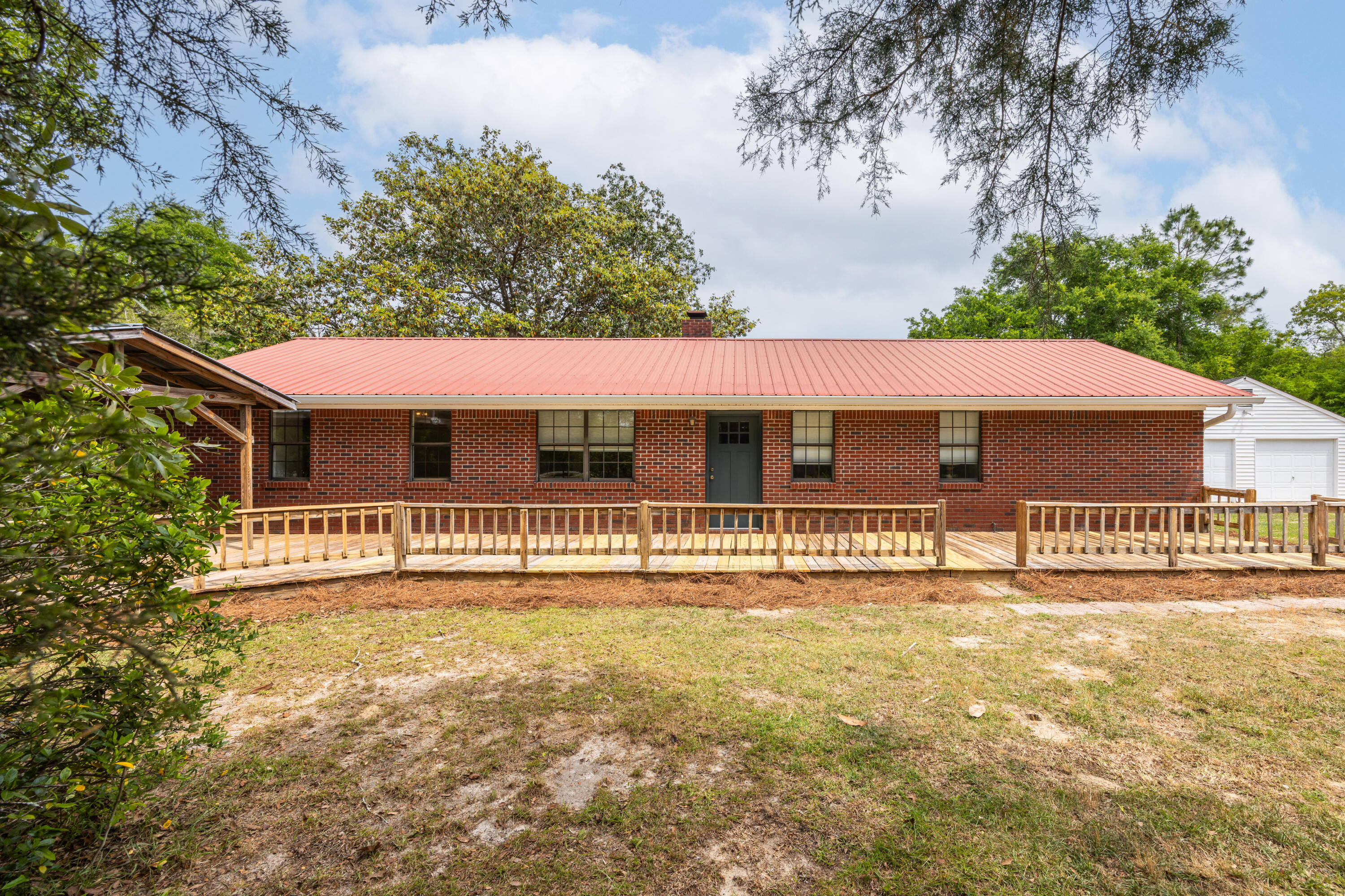 'TAKING BACKUP OFFERS!!'  Welcome to your own slice of peaceful country living--just minutes from the conveniences of DeFuniak Springs! This charming single story, brick,  3-bedroom, 2-bath home offers the perfect blend of comfort, functionality, & serene surroundings, all nestled on a fully fenced 1.14-acre property. With NO HOA & Flood zone X, this property offers the freedom & flexibility for you to be creative. 

Step inside to discover a warm & inviting interior featuring brand-new vinyl plank flooring throughout, beautiful new master-bath shower upgrades, & cozy wood-burning fireplace with blower that anchors the living room. The spacious galley-style kitchen is a true highlight, showcasing beautifully updated granite countertops, freshly painted cabinetry, & Just beyond, a large utility room--complete with washer/dryer hookups--adds even more convenience to everyday living

Outdoors, the property truly shines!!!
Mature landscaping creates picturesque setting, with thriving blueberry bushes, grapevines, crepe myrtles, azaleas, and stately oaks adding both beauty and charm. Whether you're hosting gatherings or enjoying a quiet morning, the covered gazebo/porch along with front and back decks provide ideal spaces for relaxing and entertaining. 

You'll appreciate the detached 2-car garage/workshop, offering plenty of space for projects, storage, or hobbies. If you're seeking a private retreat or envisioning your own hobby farm with a country feel--yet still close to town--this beautiful property truly delivers the best of both worlds. 

Plus, If you love the water or fishing, enjoy just around the corner  access to Juniper Lake, complete with a public boat launch and picnic area for outdoor recreation. Come experience the space, tranquility, and lifestyle you've been looking for! This also offers:
*Close proximity to world famous white-sand beaches of the Emerald Coast & 30A
*South Walton's renowned dining and shopping
*Destin's lively entertainment scene
*Eglin and Hurlburt Air Force Bases, major airports, and top-rated schools

Your Next Chapter Begins Here
This isn't just a home --it's the backdrop for a lifetime of memories.

Systems info:
Hot water tank 2021
HVAC 2013
House Roof 2013