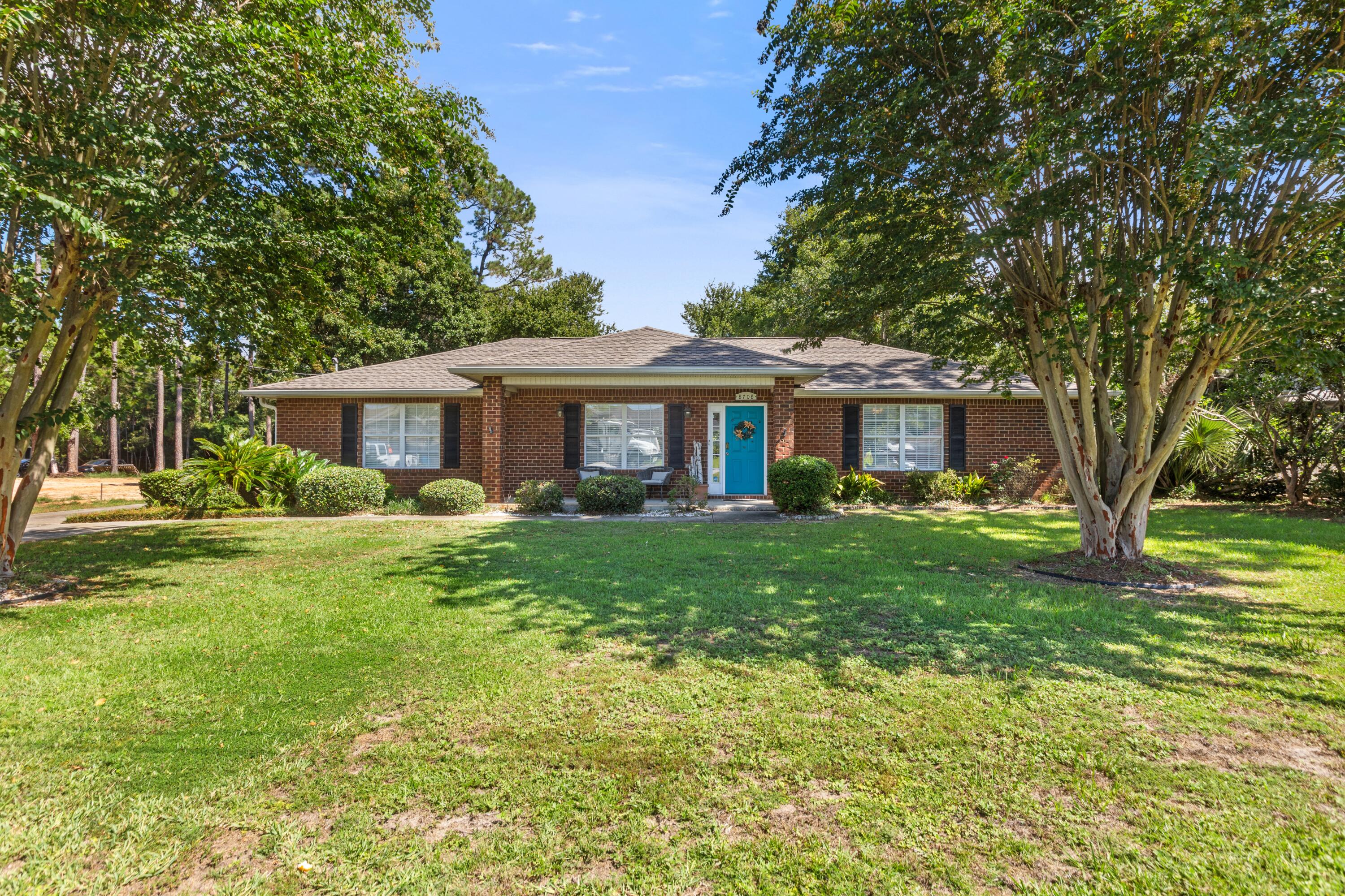 A rare find in Navarre -- this 3-bedroom, 2-bath home sits on a generous almost half acre lot, giving you space that's hard to come by this close to the coast. Whether you want room to add a pool, park a boat, or simply enjoy having neighbors at a distance, this lot delivers.

This all brick home has vaulted ceilings as you walk into the open floor plan, with neutral tile and new engineered hardwood flooring in the bedrooms. Roof is 2020(December) and HVAC is 2022

Just minutes from Navarre Beach, the home puts you within easy reach of the Gulf's sugar-white sand and emerald water, along with the shopping, dining, and everyday conveniences along Highway 98.

The real advantage here is what's already done for you: the home is being sold fully furnished, making it a true turnkey opportunity. For a buyer looking to start a vacation rental, secure a low-maintenance second home, or move in without the hassle of furnishing from scratch, this is ready to go from day one.

With its combination of lot size, location, and move-in-ready condition, 8708 Laredo St offers a straightforward path to owning on the Gulf Coast -- without the usual lead time.
Neighbor to the left is currently adding a privacy fence for even more privacy!