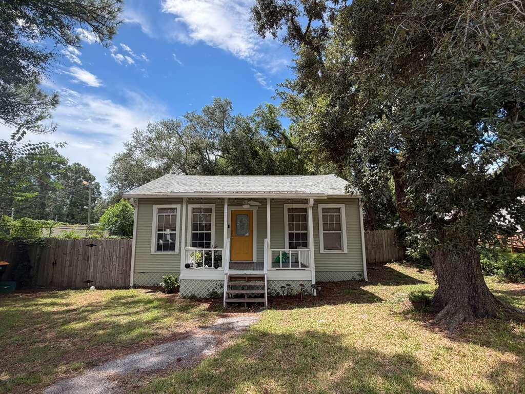 Discover ''The Coastal Cottage,'' a truly unique 2-bedroom, 2-bathroom home nestled in Fort Walton Beach, FL. This charming property offers a beautiful blend of original character and modern updates, creating a warm and inviting space that feels both comfortable and stylish.

Step inside to a bright and spacious living room featuring large windows that provide plenty of natural light, beautiful vinyl plank flooring, and a ceiling fan for added comfort. The original plank walls and ceilings throughout the home add character and charm while complementing the home's updated finishes.

The updated kitchen is a standout feature, offering crisp cabinetry, modern countertops, stainless-steel appliances, and a spacious center island with seating. Large windows above the kitchen sink bring in natural light and make the space feel open and welcoming. The kitchen provides plenty of room for preparing meals and gathering.

Both bedrooms offer comfortable living space with vinyl plank flooring, ceiling fans, and large windows that allow plenty of natural light into the rooms. The bedrooms are versatile and provide enough space for bedroom furniture, storage, or even a small workspace.

The home also features two full, updated bathrooms with modern vanities, framed mirrors, updated lighting, and clean, functional finishes. Throughout the property, the combination of updated features and original details gives the home a distinctive Coastal Cottage feel. The back yard features a nicely sized deck and privacy fencing. The Coastal Cottage is a charming Fort Walton Beach rental that combines modern comfort with timeless character, offering a cozy and inviting place to call home.

No smoking, including vaping. Pets may be considered on a case by case basis with prior approval and a non-refundable pet fee.