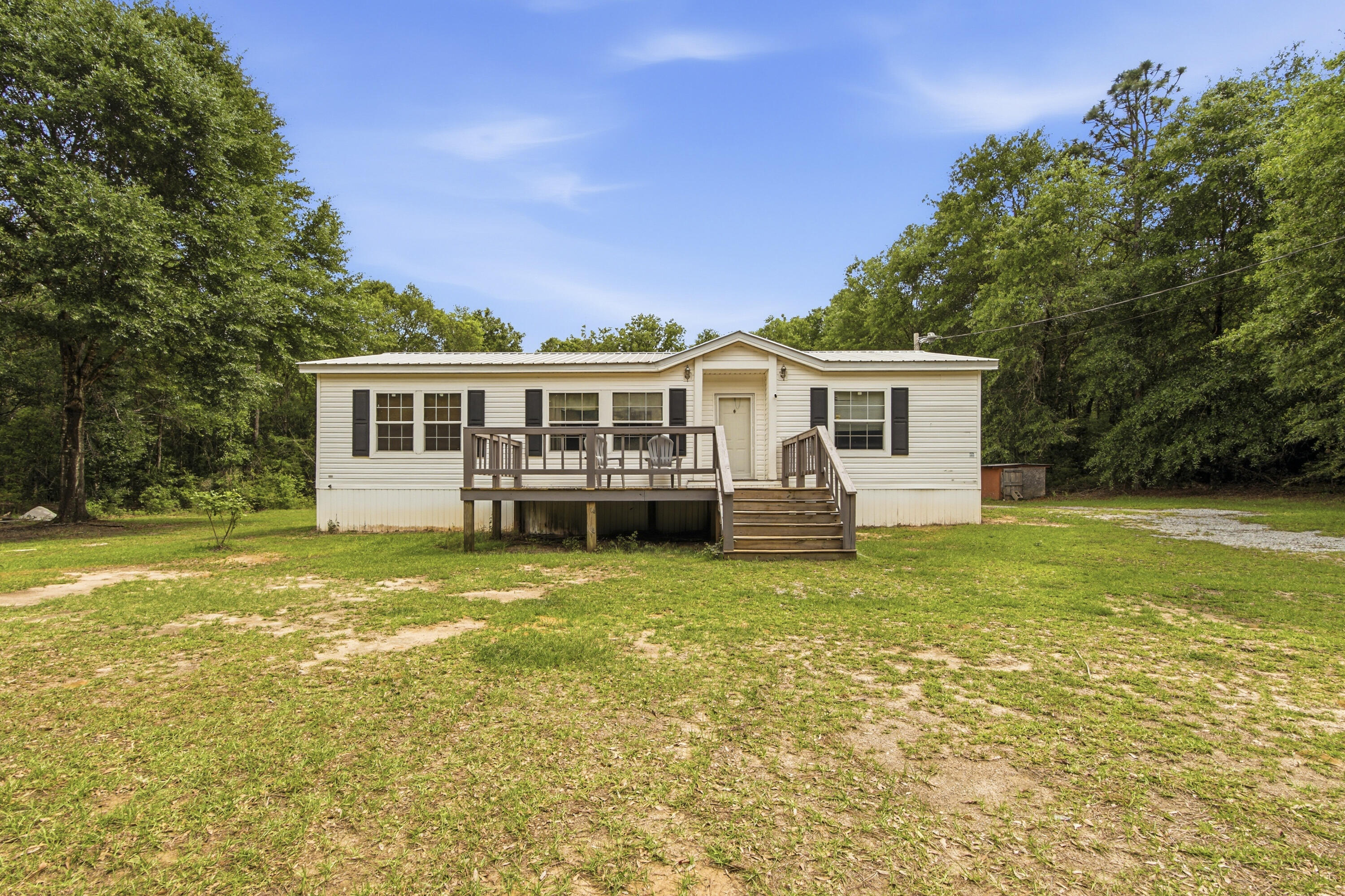 Located in the Red Level community this home has tons to offer! Just a short distance to town but gives you the privacy you desire. Sitting on 3.4 acres with a garden area this 3 BR/2BA mobile home is priced just right! Home has a large open living room with built ins, a separate kitchen and dining area as well as a split floor plan for your family. Home offers a large front and back deck perfect for morning coffee or afternoon relaxing. The property has a great garden are already established for you, a nice chicken coop, as well as a storage shed to keep all your yard tools in. Property is cleared around the home and has apple trees, blueberry trees, and blackberry bushes then is wooded in front and back. The home is also convenient to Gannt to Lake for fishing and recreation enjoyment. New HVAC in 2019, duct work and skirting around home. New metal roof in 2021. Call today to see this great buy on a little piece of heaven ready for you to call yours!