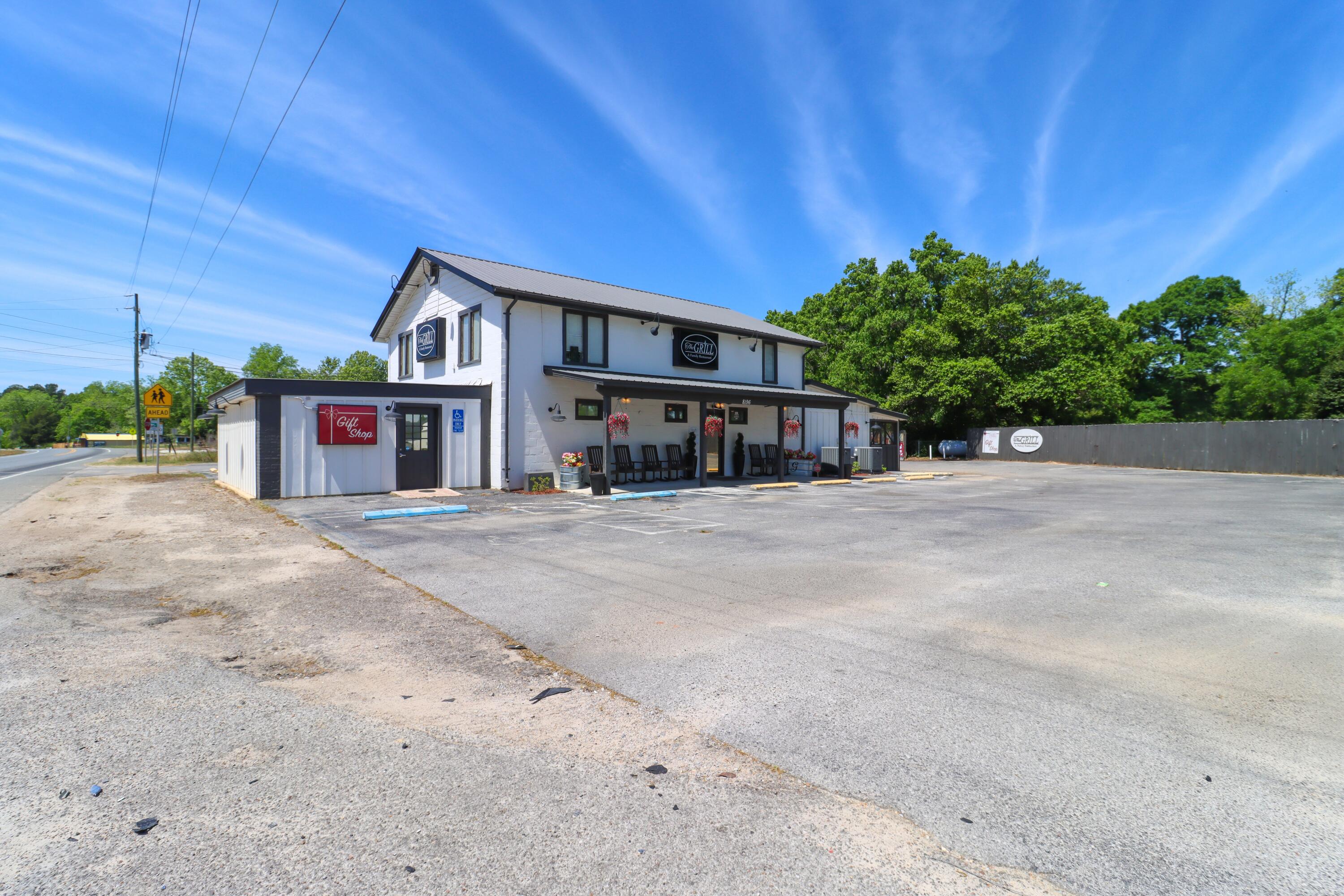 Now offered to the public, in Laurel Hill, Florida, is a unique opportunity to purchase both the real estate and operations of a long-standing, fully established restaurant business. Positioned on a combined ±1.41 acres with approximately 184ft of frontage along Hwy 85, the two-story, 3,766 SF building benefits from strong visibility, convenient access, and a well-established presence within the community. While the restaurant operates on the first floor, the second floor provides an extra ±1,302 SF of space divided among 6 rooms, allowing for alternative business uses. The sale is structured as a true turnkey operation, with major systems in place including 400-amp service, dual 5-ton HVAC units, and a fully equipped commercial kitchen with hood system, grease trap, walk-in cooler, and freezer. Other functional highlights include a dedicated drive-thru for high-volume service and a screened-in pit room featuring a large-capacity smoker. The offering includes three parcels, one of which is improved with a single-family home, providing potential for additional rental income, along with another parcel equipped with septic. Currently licensed for 88 occupants and comfortably seating 68 guests, the site provides approximately 15 dedicated parking spaces with ample room for overflow. Between the operationally robust infrastructure, and a loyal local customer base, this property represents a rare, income-producing asset, whether for an owner-operator looking to take the reins of a local staple or an investor seeking a property with significant future upside!