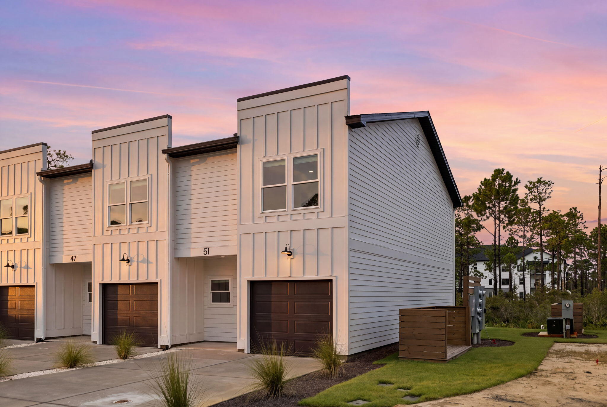 Tucked among the trees in Santa Rosa Beach, Hidden Pines is a gated community of just 42 modern townhomes off Goldsby Rd -- low-density by design, with protected wooded views that set it apart from anything else on the market. This 3-bedroom, 2.5-bathroom OSPREY FLOORPLAN is new construction done with intention.

The community's low density is a feature in itself. Protected wooded views, a natural canopy overhead, and a quiet residential feel set the tone from the moment you arrive. Centrally positioned between Santa Rosa Beach and Destin, with Ascension Sacred Heart Emerald Coast just minutes away, the location balances coastal lifestyle with everyday convenience.
Outside, the homes make a quiet statement -- white vertical panel siding, warm-toned garage doors, black exterior sconces, and mature landscaping that softens the streetscape without competing with it. The aesthetic is modern coastal with staying power.

Inside, the interiors reflect a cohesive, light-filled design vision. Walls are painted in Sherwin Williams Snowbound, a crisp warm white that lets the natural light lead. Wide-plank wood-look flooring runs continuously throughout every level. The kitchen is anchored by Arctic White quartz countertops, shaker-style cabinetry, a classic white subway tile backsplash, and a Pfister chrome faucet. Above the island, two globe pendants cast a warm glow; a chrome taper candle chandelier anchors the dining space with quiet elegance.

Bathrooms are finished with equal care Glacier Statuary porcelain shower panels with continuous vertical veining, undermount sinks, Arctic White quartz, frameless mirrors, and chrome vanity sconces. Pfister fixtures are used throughout, finished in polished chrome for a clean, consistent look from room to room.

Ceiling fans in every bedroom and the living room, 4" LED canless downlights, and thoughtfully placed exterior sconces round out a finish package that is complete and move-in ready. A private patio extends the living space outdoors, and select homes include a covered balcony off the primary suite.

Special Financing Incentive: Buyers who utilize the seller's preferred lender and title company are eligible to receive a $2,500 lender credit plus a seller credit equal to 1% of the purchase price at closing. Contact listing agent for details.

*Prices, plans, features, and options are subject to change without notice. Square footages are approximate. Home information including features, finishes, and available options are subject to change without notice. Artist renderings, photos, colors, and features are for illustration purposes only and may vary from the homes as built. Photos are of a similar unit -- features and finishes may vary. Additional restrictions may apply.*