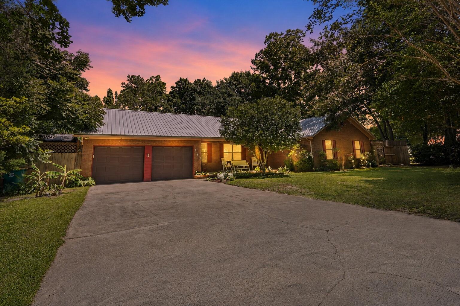 Beautifully updated home filled with natural light and designed for comfortable living.  The inviting living are features a stunning gas fireplace creating a warm focal point for gatherings or simply relaxing. Enjoy peace of mind with a newer METAL ROOF, HVAC and Hot water heater. NEW APPIANCES and garbage disposal.
A unique heated and cooled garage offers incredible flexibility - traditional garage, game room or bonus living space.  
The UPDATED kitchen flows seamlessly into the dining area, making family dinner and hosting easy and enjoyable. And don't forget the panty area - its huge!
Spacious bedrooms provide ample room for larger furniture.
Step outside to a gardener's paradise.  The fully fenced (3 years old) backyard is lush and vibrant, featuring a sprinkler system on well water with a variety of plantings including blueberry bushes, tangerine and lemon trees, gardenias, ginger, peach, apple, banana tree and an abundance of flowers - your own private oasis. Need a place to store your equipment - no problem!  There is a sizeable work shed with electricity.
This home offers a perfect blend of charm, functionality and outdoor beauty - don't miss the opportunity to make it yours!