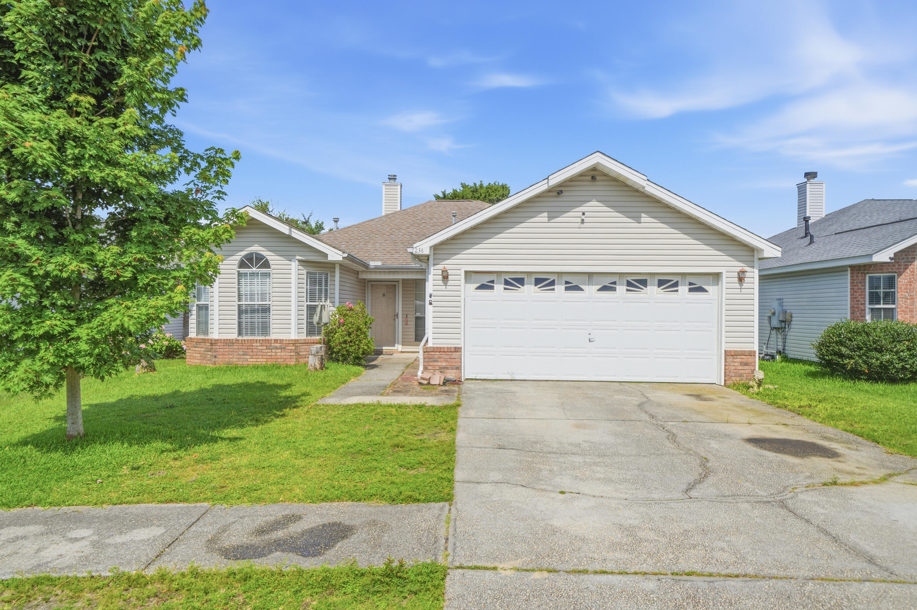 This home qualifies for 100% financing with a PATH product!  Opportunity awaits in the heart of Destin! This 3-bedroom, 2-bath home is full of potential and ready for your personal updates and vision. Featuring a desirable split-bedroom floor plan, the home offers spacious living areas with architectural details including cathedral and tray ceilings, a bay window, and a ceramic tile fireplace with wood mantel as the focal point of the living room. The eat-in kitchen provides excellent space for gathering and entertaining. French glass doors open to a versatile enclosed room currently being used as an office, offering endless possibilities for a sunroom, playroom, hobby space, workout room, or additional living area. Outside, enjoy a fenced backyard with a 6-foot privacy fence, sprinkler system, and lawn pump. Ideally located near public boat ramps, waterfront parks, and just minutes from Destin's world-famous beaches, harbor, shopping, dining, and entertainment. Whether you're looking for a primary residence, starter home, investment property, or renovation opportunity, this home offers incredible potential in a prime location. Bring your vision and make this Destin gem your own! Schedule your showing today.