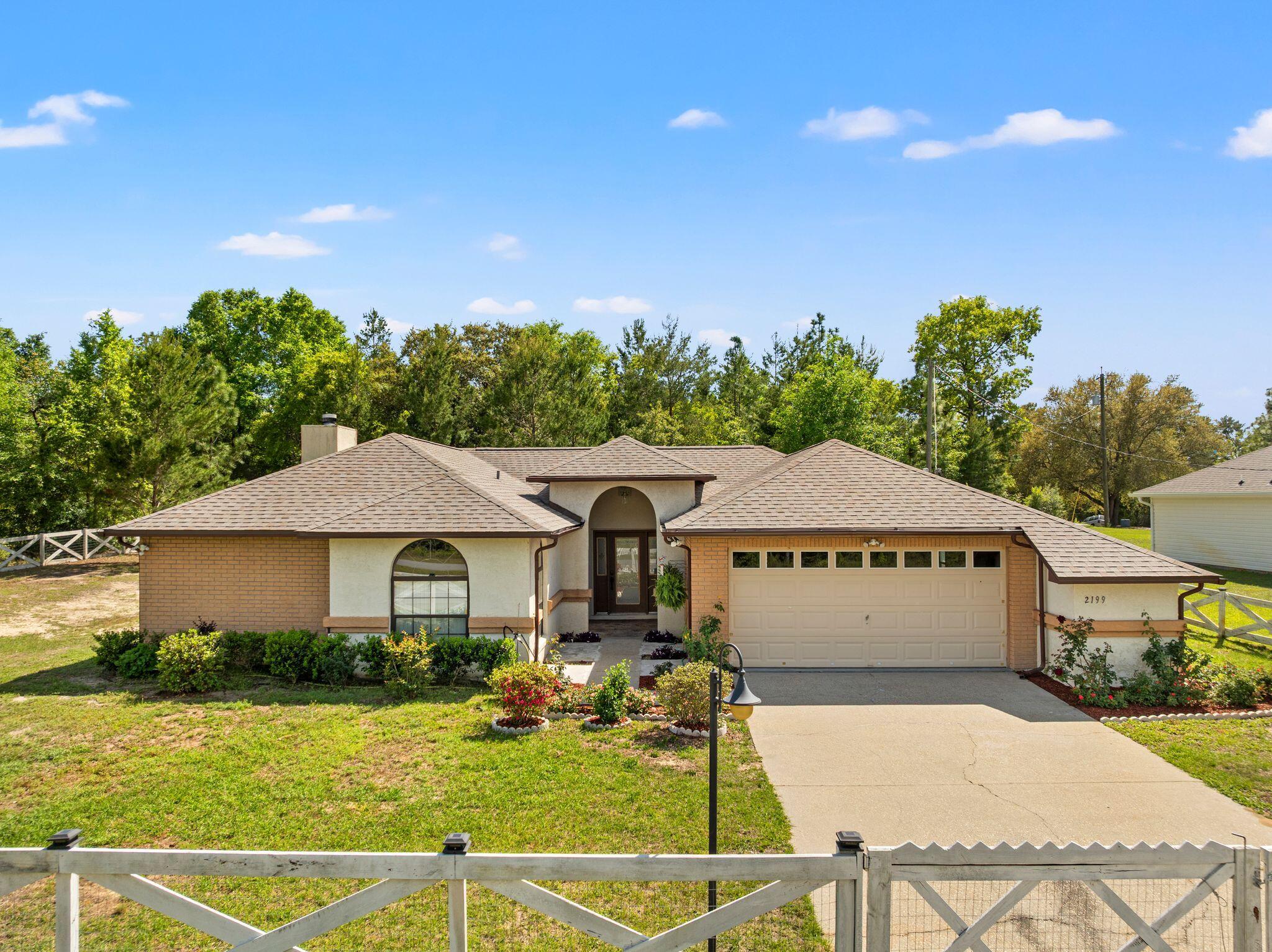 Welcome to this beautifully maintained home in the peaceful community of Sunny Hills! Featuring an inviting open-concept layout, this spacious 3-bedroom, 2-bath home offers comfortable living and effortless entertaining. The kitchen shines with granite countertops, newer appliances, abundant storage, a breakfast bar, and a pantry, while a stylish wet bar adds an extra touch for entertaining. Enjoy cozy evenings by the wood-burning fireplace or step outside to the private patio and beautifully landscaped yard.

The split-bedroom floor plan provides privacy, with a spacious primary suite featuring a newly updated bathroom with double vanity, tiled floors, stone shower, and Bluetooth exhaust fan. Additional highlights include a large garage with extra storage, sprinkler system, covered front entry, and a new roof installed in 2026.

Located just minutes from Boat Lake, nearby fishing ponds, and lakes, and conveniently situated between Chipley and Panama City. Panama City Beach is approximately 40 miles away, offering the perfect blend of peaceful living and easy access to coastal attractions.