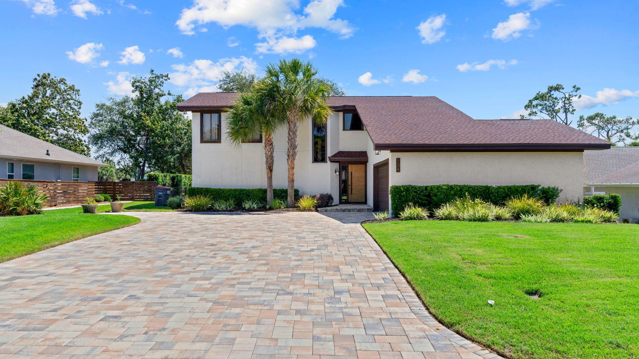 Bay Point Beauty - Updated, Inviting, and Ready to Enjoy!

Welcome to a home where timeless charm meets modern comfort in the prestigious gated community of Bay Point. Nestled among mature oak trees and beautifully landscaped grounds, this thoughtfully updated 4-bedroom, 2.5-bath residence offers an exceptional blend of warmth, style, and everyday livability.

From the moment you arrive, the oversized paver driveway, lush landscaping, and elegant accent lighting create a memorable first impression. Inside, soaring vaulted ceilings and abundant natural light enhance the spacious living room, where a wood-burning fireplace serves as a welcoming centerpiece for gatherings with family and friends.

The beautifully updated kitchen is designed to inspire, featuring granite countertops, stainless steel appliances, a glass cooktop, recessed lighting, a stylish tile backsplash, and a cozy breakfast area. Seamlessly connected living and dining spaces flow effortlessly to the expansive covered deck, creating the perfect setting for entertaining, outdoor dining, or simply relaxing while enjoying the peaceful backyard framed by majestic oak trees.

The spacious primary suite provides a private retreat with direct access to its own deck, offering a tranquil place to start or end your day. The ensuite bathroom features dual vanities, tiled flooring, and a large walk-in tiled shower with built-in bench seating. A versatile bonus room on the main level offers endless possibilities as a home office, library, media room, or flex space to suit your lifestyle.

Upstairs, a charming overlook adds architectural character while connecting three generously sized bedrooms and a well-appointed full bath with dual vanities. One of the bedrooms enjoys private access to a covered balcony overlooking the backyard, creating a peaceful escape for guests or family members.

Additional features include a two-car garage with durable epoxy flooring, a 2019 roof, updated HVAC systems (2018-2023), and a 2018 water heater, providing added peace of mind.

Living in Bay Point means enjoying one of Panama City Beach's most desirable gated communities, complete with 24-hour roving security, access to the renowned Nicklaus Course at Bay Point, and the world-class Point South Marina, which offers full-service marina amenities and slips accommodating vessels up to 120 feet.

This is more than a home; it's an opportunity to embrace the Bay Point lifestyle, where comfort, beauty, and coastal living come together in perfect harmony.