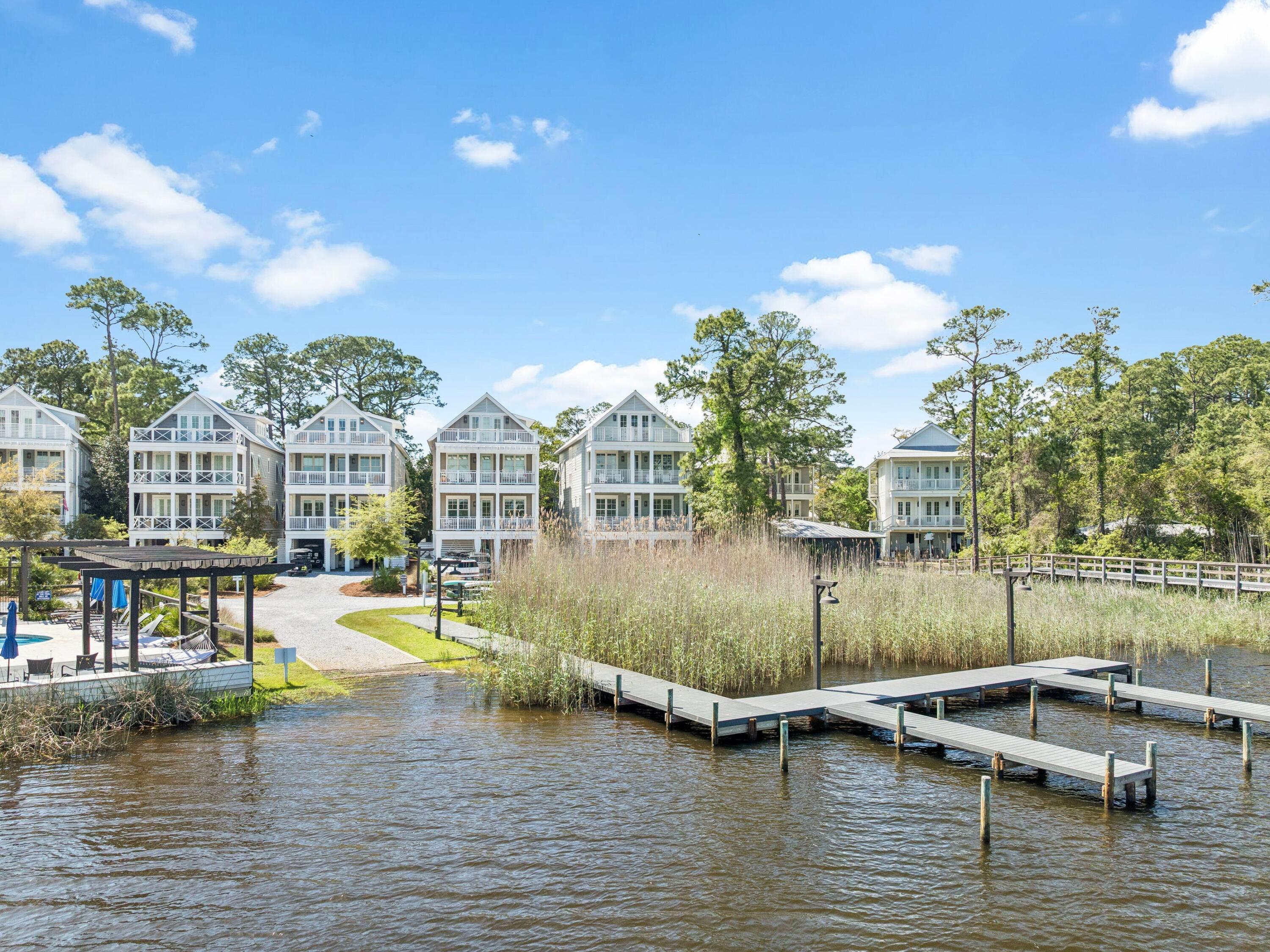 Set within the exclusive gated enclave of Grayton Landing, this custom-built five-bedroom, five bathroom and a half bath coastal retreat offers one of the best views Grayton Landing has to offer, with sweeping, serene vistas of Western Lake, a rare blend of refined design and serene waterfront living. Overlooking the tranquil waters of Western Lake, the 3,563-square-foot residence captures breathtaking views and effortless indoor-outdoor living at every turn. Thoughtfully designed by Luke & Blue, the home features a light-filled open-concept layout anchored by a chef's kitchen with premium appliances, custom cabinetry, and elegant stone surfaces. Expansive living and dining spaces flow seamlessly onto covered porches, inviting relaxed mornings and sunset evenings overlooking the lake and resort-style pool.

Multiple ensuite bedrooms, including two luxurious primary suites, provide private retreats for family and guests, while a top-level bunk room, loft, and open-air terrace offer additional space for gathering and entertaining.

Complete with private lake access, a deeded dock and boat slip, and just moments from the sugar-white sands of the Gulf of Mexico, less than half a mile walk to the beach, this exceptional residence embodies the essence of elevated 30A living.
