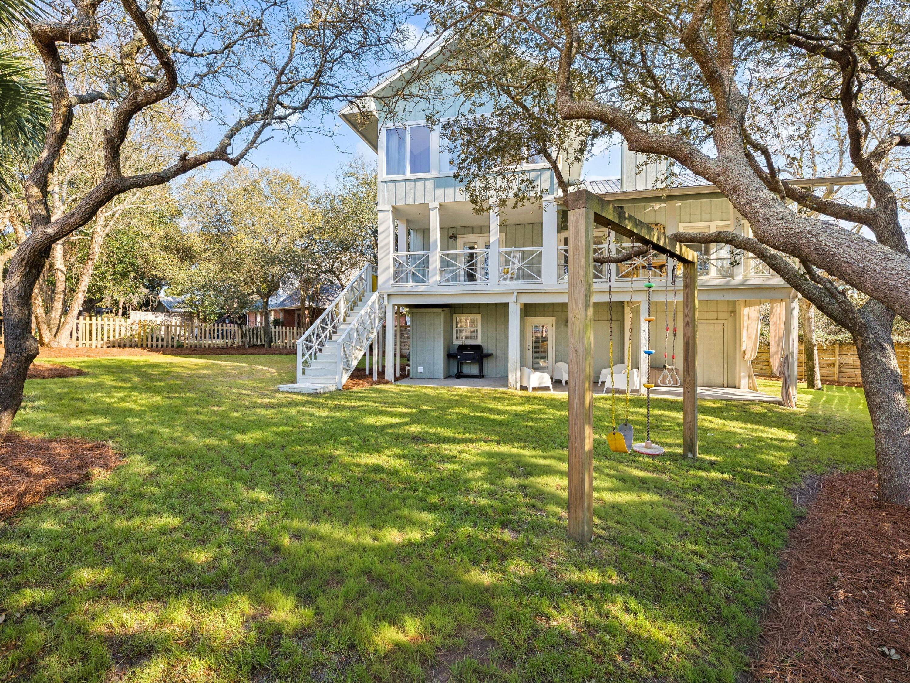 Located on a spacious quarter-acre lot in the Beach Highland community of Dune Allen, this 3 bedroom, 3 bath home offers an excellent opportunity for a primary, second home, or vacation rental with just a short stroll to the public beach access across from Stinky's restaurant. The main living areas occupy the second and third levels, featuring an open-concept kitchen and living room with vaulted ceilings and access to a spacious porch overlooking the backyard. The kitchen includes a large island, farmhouse sink, and beadboard cabinetry for a classic coastal feel. The tree-lined backyard provides ample room for a swimming pool to be added. The second level includes a guest bedroom, full bath, and laundry, while the third floor primary suite offers a walk-in closet, en-suite bath, and bonus flex space. The ground level features a separate lock-out apartment which includes a kitchenette, living area, bedroom, bath, and laundry. A perfect, private first floor guest suite. Come enjoy all that Beach Highland has to offer.