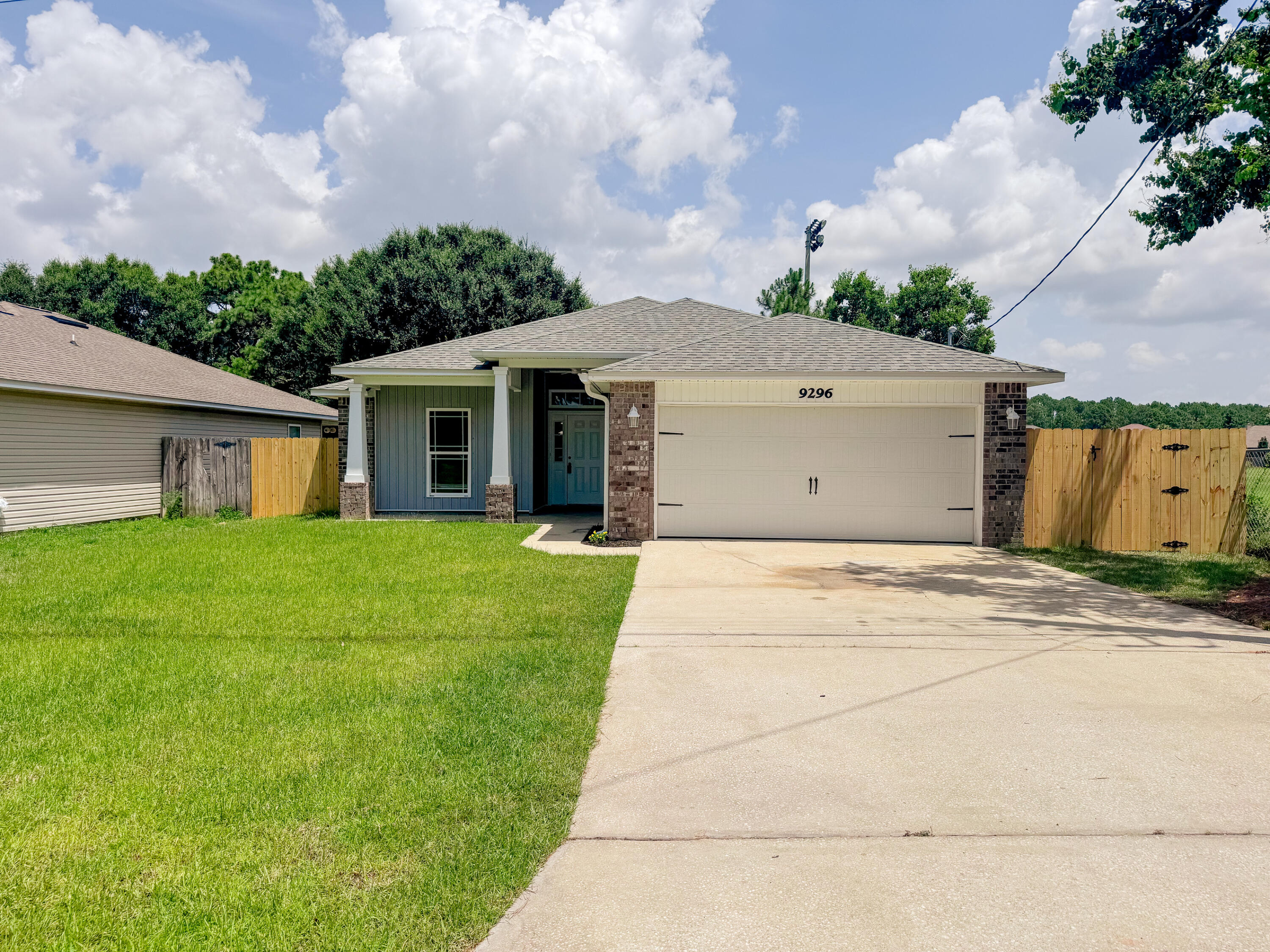 Beautifully renovated 4-bedroom, 2-bath home in the heart of Navarre! This 2014 build is move-in ready featuring a desirable split-bedroom floor plan, modern finishes, and an open-concept layout designed for comfortable living and entertaining. Step inside to vaulted ceilings, abundant natural light, and luxury vinyl plank flooring throughout. The beautifully updated kitchen showcases new quartz countertops, new cabinetry, brand-new stainless steel appliances--including an electric range, microwave, and dishwasher--and a large breakfast bar overlooking the spacious living and dining areas. The private primary suite offers dual walk-in closets and a beautifully renovated ensuite main bath featuring dual vanities, a relaxing garden tub, and a separate floor-to-ceiling tiled walk-in shower. Three additional bedrooms and a full guest bath provide flexibility for family, guests, or a home office. Situated on a deep 0.36-acre lot, the backyard offers exceptional outdoor space with a wooded backdrop for added privacy. Enjoy relaxing or entertaining from the covered patio with ceiling fan while taking in the peaceful setting. The attached two-car garage and extended driveway provide plenty of parking and storage. Conveniently located near schools, shopping, dining, adjacent to Navarre soccer park and just minutes from Navarre's beautiful white-sand beaches, this home offers the perfect combination of style, space, and location. Schedule your private showing today!