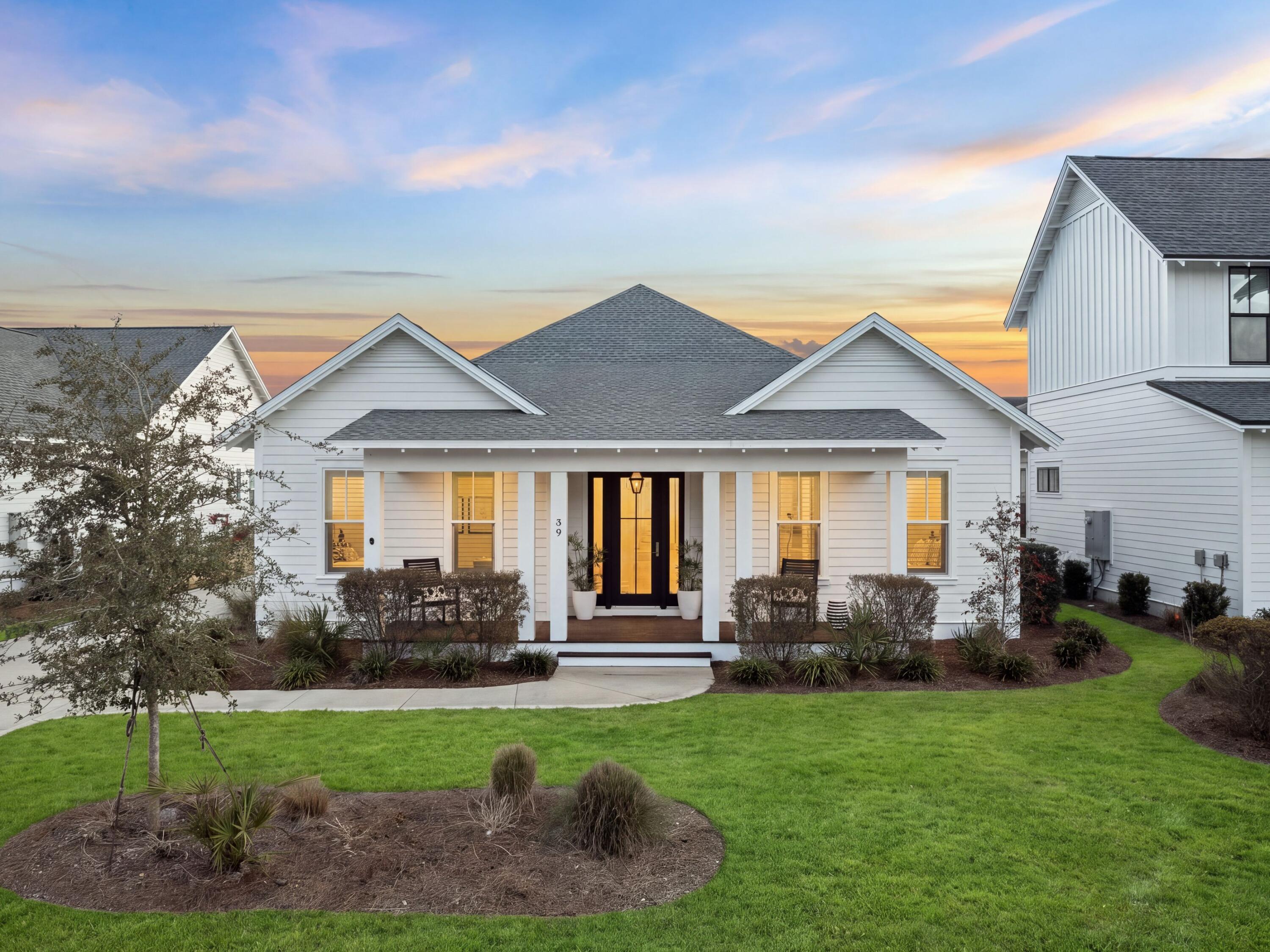 Nestled within the highly sought-after Watersound Origins community, 39 West Firethorn Circle offers an inviting blend of classic coastal architecture, elevated interiors, and seamless indoor-outdoor living. Charming front porches, timeless coastal accents, and a well-planned single-story design create a home that feels both sophisticated and effortlessly comfortable.

Offering approximately 2,612 square feet, this four-bedroom, three-bath residence is thoughtfully designed with everyday living and entertaining in mind. Wide-plank wood floors, 10-foot ceilings, and an abundance of natural light contribute to the home's bright and airy ambiance. The open living area centers around a beautiful shiplap fireplace feature and transitions naturally into the gourmet kitchen. Custom cabinetry, quartz countertops, stainless steel appliances, and an oversized island create a functional and inviting space for gathering. Designer pendant fixtures and carefully selected finishes bring an elevated aesthetic while maintaining the relaxed character of coastal living. The single-level floor plan provides four spacious bedrooms and three full bathrooms, offering an ideal balance of shared living spaces and private retreats. The primary suite is especially tranquil, featuring generous natural light and a spa-like bathroom with dual vanities, polished finishes, and a large walk-in closet.

The home continues to shine outdoors, where a generously sized screened-in rear porch overlooks the fenced backyard. This private outdoor setting provides an ideal extension of the living space for morning coffee, dining, entertaining, or simply enjoying the coastal surroundings. A two-car garage provides additional convenience and storage.

Life in Watersound Origins comes with an exceptional selection of amenities at Village Commons, including a resort-style swimming pool, fitness center, tennis and pickleball courts, scenic walking and biking trails, and community access to Lake Powell. Residents also enjoy the Origins Golf Course and an enviable location near Scenic Highway 30A, Watersound Town Center, area restaurants, and the Gulf's beautiful white-sand beaches.

Combining refined interiors, comfortable living spaces, inviting outdoor areas, and access to an exceptional collection of amenities, 39 West Firethorn Circle captures the relaxed sophistication of coastal living in Watersound Origins.