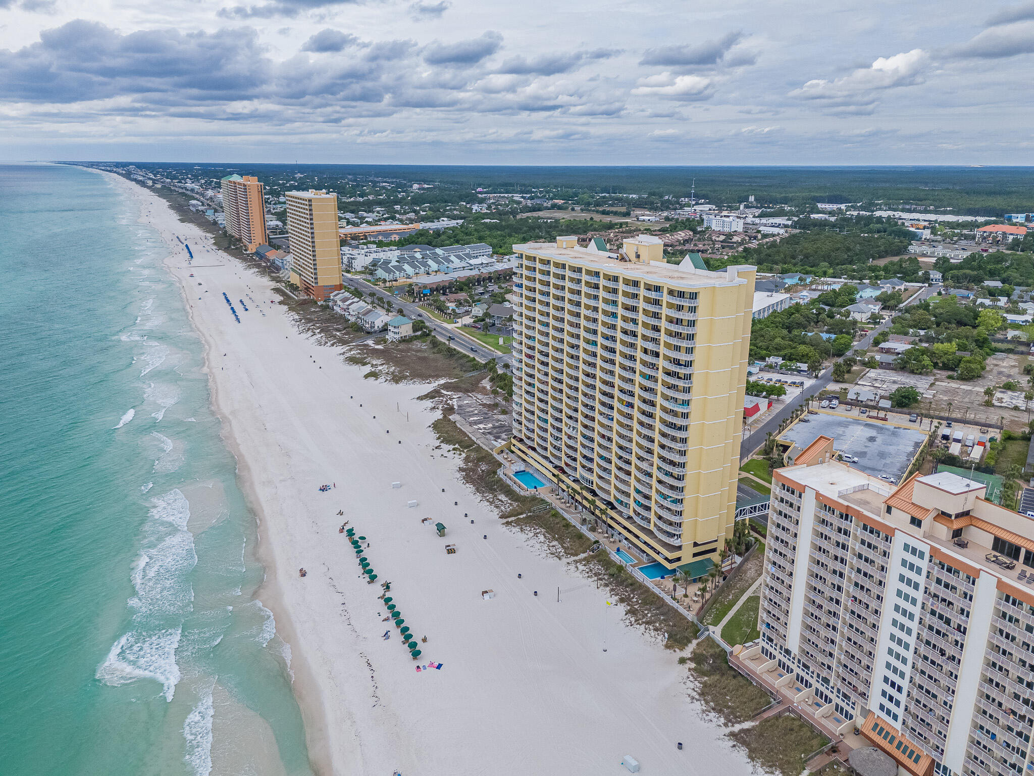 'CURRENTLY UNDER CONTRACT, SELLER WILL CONSIDER BACKUP OFFERS' DEEDED PARKING SPACE INCLUDED. This spacious, bright Gulf-front condo at Emerald Isle offers the ideal mix of personal beach retreat and income-producing investment, previously averaging approximately $58,000 in annual gross rental revenue, making it perfect to enjoy part-time while helping cover costs and generate cash flow. The open layout features 9' ceilings, crown molding, luxury vinyl plank flooring, and abundant natural light, with seamless flow between the living, dining, and kitchen areas centered around Gulf views, while the kitchen includes granite countertops and a breakfast bar. A standout feature is the oversized 10.5' x 28' curved Gulf-front balcony with panoramic coastline views, accessible from both the living area and the Gulf-front primary suite, and each bedroom offers private bathroom access for added comfort. Recent updates include a new HVAC (Nov 2024) and 2020 water heater, along with a stacked washer/dryer, exterior storage closet, and deeded parking space located just steps away from the elevators. Residents enjoy resort-style amenities including Gulf-front pools, hot tubs, steam room, fitness center, and covered parking, with HOA fees covering everything except electricity and pet-friendly ownership. Located on the west end of Panama City Beach just minutes from Pier Park, dining, and entertainment, this condo offers both convenience and a laid-back coastal lifestyle.