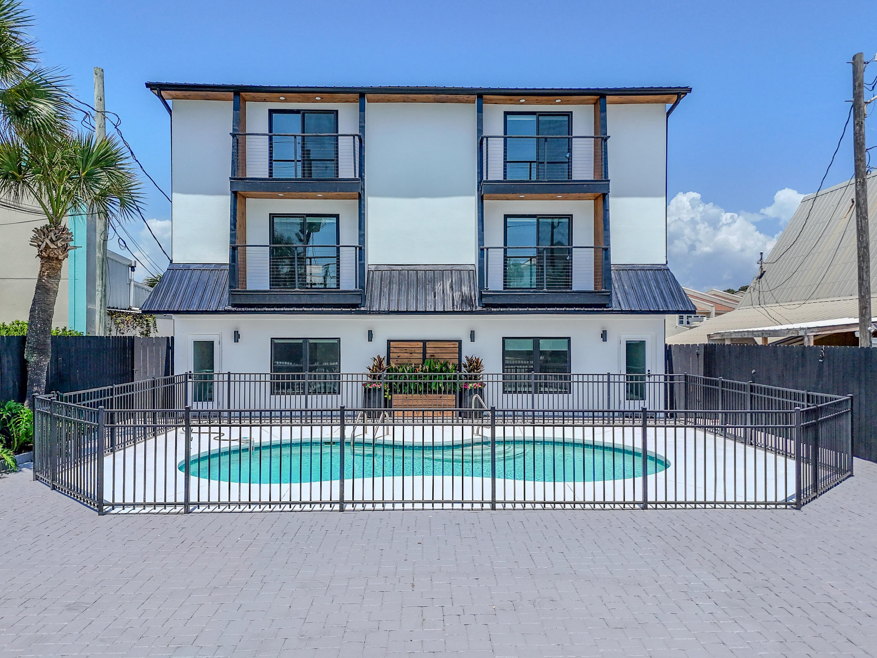 Completely reimagined and extensively renovated in 2026, this Miramar Beach duplex offers two identical three story residences totaling 5,040 square feet of heated and cooled living space. With no HOA, deeded beach access directly across Scenic Gulf Drive, Gulf views, a fenced shared pool, and an updated paved driveway with on site parking, this is a rare Emerald Coast opportunity.

Each residence offers approximately 2,520 square feet with 4 bedrooms, 3 full bathrooms, and 1 half bathroom. The first floor includes two bedrooms, a full bathroom, and a spacious living area with direct pool access. One first floor bedroom in each residence features custom built bunk beds for additional sleeping accommodations.

The second floor features an open living and dining area, half bathroom, Gulf view balcony, and updated kitchen with quartz countertops, white shaker cabinetry, subway tile backsplash, stainless steel appliances, and generous storage. The third floor provides two bedrooms, two full bathrooms, and an additional Gulf view balcony.

Permitted improvements include a metal reroof, siding, doors, flooring, sheetrock, kitchens, bathrooms, water heaters, vanities, plumbing and electrical fixtures, trim, ceiling fans, lighting, paint, and refreshed exterior amenities. This property offers exceptional flexibility for investment, multigenerational living, or a coastal retreat.