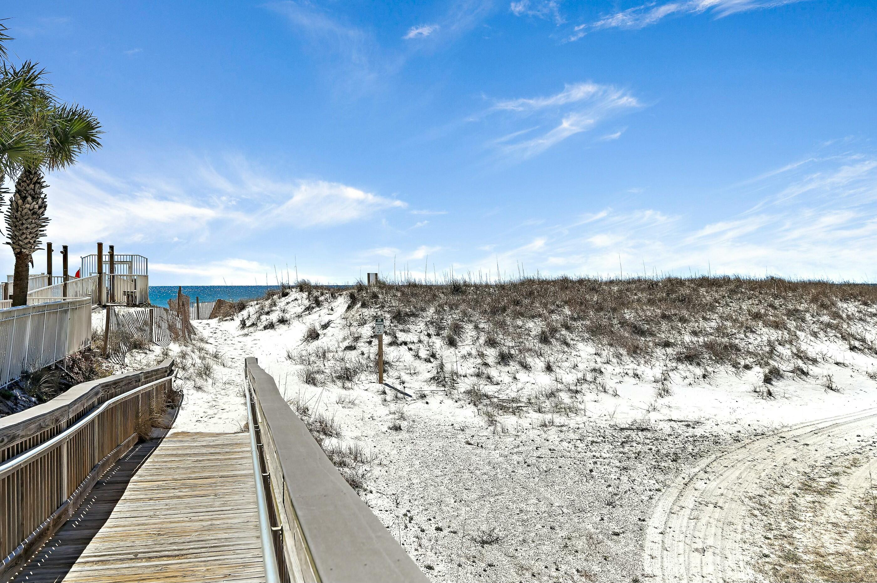 Experience the convenience of being located South of Highway 98, where your walk to the beach never requires crossing a highway. This ground-floor corner unit is among the closest in the community to the gated, deeded beach, placing Destin's sugar-white sand and emerald green water just steps away. The covered patio overlooks the pool, creating the perfect spot to unwind after a day at the beach. Inside, the kitchen features granite countertops, stainless appliances, custom cabinetry, and a breakfast bar open to the living area. An exterior storage closet provides added space for beach chairs, toys, and fishing gear.

St. Martin Beachwalk is a low-density community offering a private pool, BBQ grilling area, and gated deeded beach access. Conveniently located near Destin Harbor, HarborWalk Village, Big Kahuna's Water & Adventure Park, dining, shopping, and entertainment, this property is ideal as a primary residence, vacation retreat, or investment opportunity.