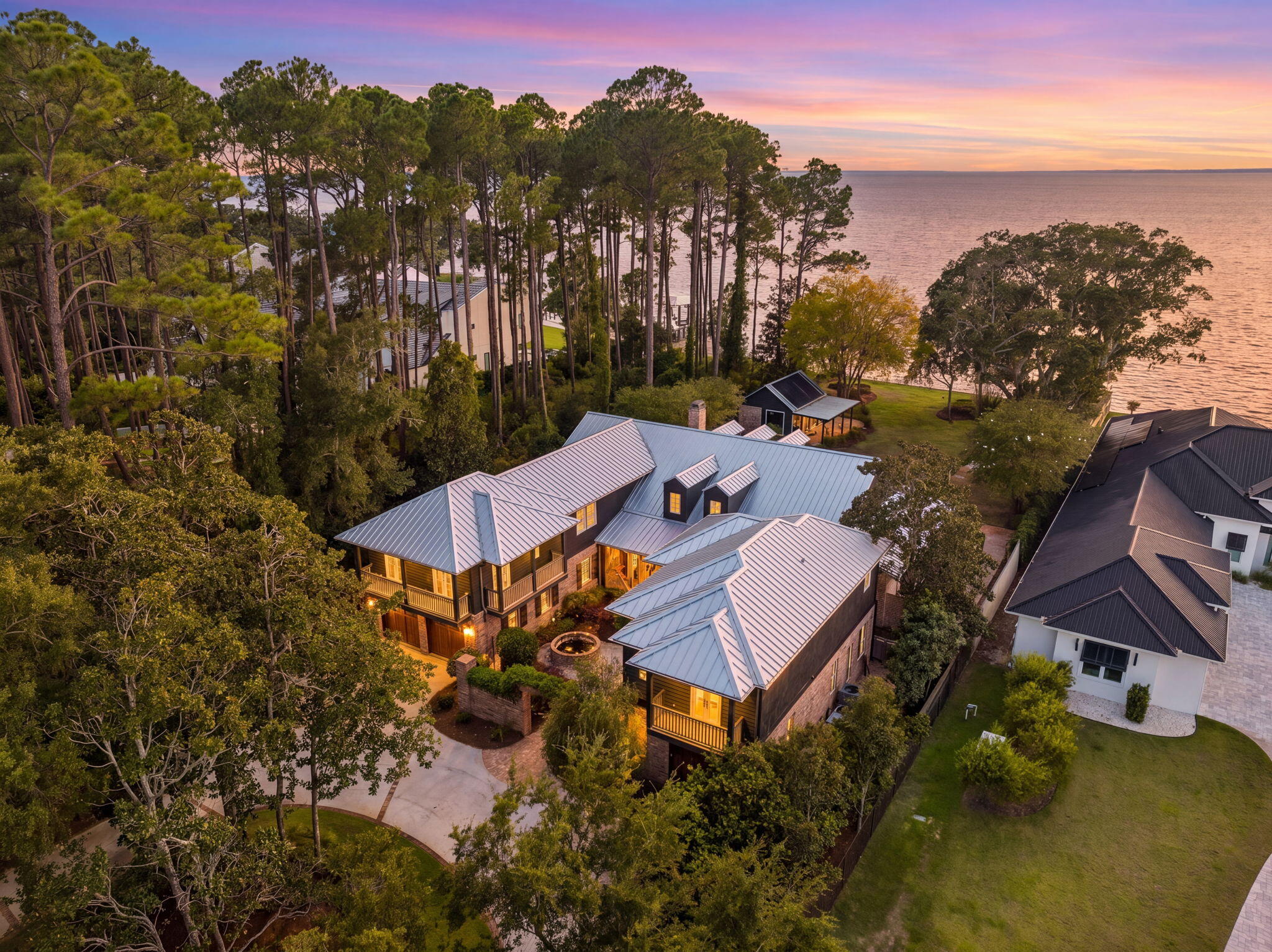 Set along the peaceful shores of Choctawhatchee Bay, 389 Driftwood Point Road is a remarkable waterfront estate where architectural character, privacy, and the beauty of bayfront living come together. Set on 1.1 private bayfront acres, this custom estate offers the perfect balance of luxury and the effortless waterfront lifestyle that makes Santa Rosa Beach so desirable.

Spanning 7,216 square feet, the property features a 4-bedroom, 3.5-bath main residence and a detached 2-bedroom, 2-bath guest house, creating exceptional flexibility for hosting family, friends, or extended stays. Complete with a private dock and resort-style outdoor living, every space is thoughtfully designed for entertaining and making the most of life on the bay.

The residence reflects timeless architectural character and craftsmanship. Blending the charm of New Orleans architecture with the relaxed elegance of the Emerald Coast, the home showcases antique doors, Old Chicago brick, copper gutters, private balconies, and inviting courtyards that give the estate a sense of history, warmth, and authenticity.

Inside, you'll find a chef's kitchen with premium appliances, a spacious bayfront primary suite with a beautifully appointed bath that opens directly to a private courtyard for a true retreat, flexible bonus spaces, a separate guest wing complete with its own full kitchen, and the detached guest house offering a private retreat for visitors or multigenerational living. Outside, the estate transforms into a true waterfront oasis. The expansive backyard is centered around a 20-by-40 resort-style pool, while the pool house serves as the ultimate entertaining hub with a summer kitchen, convenient half bath, and relaxed gathering space perfect for cookouts, game days, sunset dinners, or unwinding after a day on the water. Every space is designed to bring family and friends together while embracing the beauty of the waterfront setting.

The private dock is equipped with two boat lifts, a boathouse, a jet ski lift, and a kayak launch, providing effortless access to boating, fishing, paddleboarding, and endless days exploring Choctawhatchee Bay.

Conveniently located just minutes from Grand Boulevard, Sacred Heart Hospital, top-rated schools, and the sugar-white beaches of 30A, this exceptional bayfront estate delivers a distinctive combination of architectural significance, peaceful waterfront living, privacy, and everyday convenience.