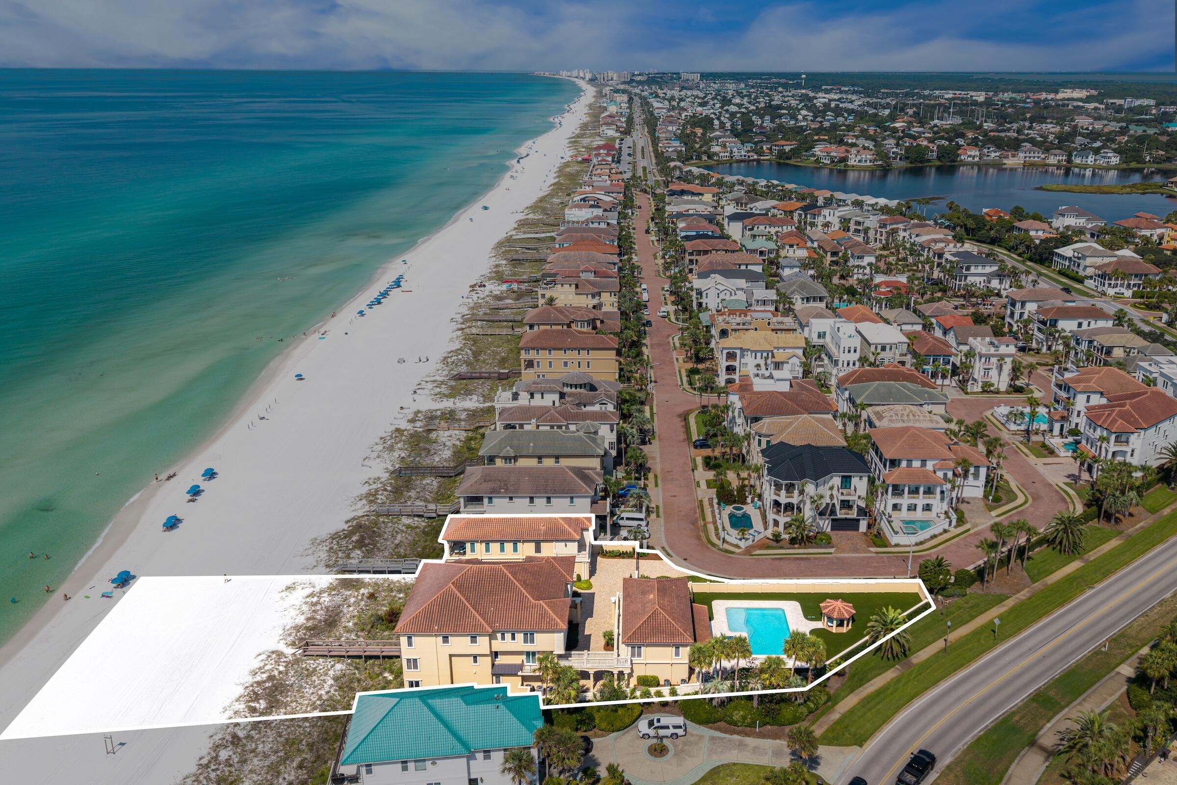 Some homes are purchased. Others are passed down.
Positioned along more than 140 feet of pristine Gulf frontage in Destin's most exclusive guard-gated neighborhood, Destiny by the Sea, this singular three-parcel estate is a rare offering of scale, privacy, and permanence. Listing includes three separate parcels: 4774, 4770, and 4772 Ocean Blvd., offered together as one package.
Lovingly assembled over the years and now offered for sale as a complete estate, this extraordinary property encompasses more than 12,000 square feet across three distinct dwellings and 12 bedrooms. Sold fully and fabulously furnished, it is a remarkable Gulf-front compound designed not simply for today, but for generations to come.
The estate's elegant design is refined without being pretentious, creating spaces that feel both impressive and wonderfully livable. Throughout, the interiors remain peaceful and serene, while virtually every room draws the eye toward the crystal-clear Gulf waters beyond. Thoughtfully designed and reimagined through the years, the property remains classic while feeling completely current.
The main Gulf-front residence encompasses more than 10,000 square feet, including its private attached casita, and offers nine bedrooms, multiple Gulf-front balconies, and an extraordinary collection of spaces designed for both grand entertaining and intimate family life. Upon entering, a dramatic three-story atrium rises overhead, illuminated by sparkling crystal and framed by two levels of graceful circular balconies. A sweeping curved staircase creates a memorable first impression, while an elevator provides access to all three floors. Three full laundry rooms--one on each floor--serve the main residence.
The first floor was designed for fun, gathering, and making memories. A six-seat private theater invites starry-night movie watching. The adjacent game/card room--formerly configured as a downstairs bedroom and complete with its own private bath--provides the perfect setting for family game nights, cards, and lively gatherings. A dreamy first-floor powder room becomes a work of art with its hand-painted mural celebrating the beauty of nature.
The main living spaces are equally inviting, with generous room for conversation, entertaining, and uninterrupted Gulf-front dreaming. Original artwork and rich mahogany cabinetry add warmth and character, while the expansive redesigned kitchen was thoughtfully conceived around the art of gathering. Two substantial islands command the room, surrounded by soothing cream-toned quartz and quartzite surfaces and an exceptional collection of appliances, including a fully paneled Sub-Zero refrigerator/freezer, dual beverage drawers, Bosch dishwasher, dedicated ice maker, and full-height paneled pantry. Glossy travertine flooring extends throughout the first level.
The second floor offers four spacious private bedrooms, each with a sumptuous ensuite bath. Two enjoy direct Gulf frontage and private Gulf-front balconies - wake to the water and fall asleep to the sound of the surf.
The third floor is a private retreat unto itself, with two additional whimsical ensuite bedrooms and an exceptional primary suite occupying the eastern corner of the residence. The primary suite features its own Gulf-front balcony with views that capture both sunrise and sunset, along with a full-sized sitting room, luxurious bedding, and an opulent bath appointed with a fainting sofa, soaking tub, and dual shower. It is a space designed to make lingering feel like a privilege.
Connected to the main residence by a suspended footbridge, the private casita introduces a lighter, more nautical expression of the estate. Overlooking the resort-style 27,000-gallon pool, it provides two full-sized ensuite bedrooms, an upstairs den, and an oversized downstairs gathering room with large-screen television--perfect for spirited sports watching, family celebrations, and poolside afternoons. The downstairs bath also serves the pool, and the casita includes its own single-car garage.
For those seeking even greater privacy, a separate guest home, occupies a quiet corner of the estate overlooking the Gulf. Light, bright, and distinctly coastal, its wood floors and shiplap-paneled walls embrace the relaxed character of beach living. A downstairs ensuite bedroom opens to its own private Gulf-front balcony, ideal for an afternoon nap accompanied by the sound of the waves. An additional ensuite bedroom upstairs overlooks the pool, while the upper level opens toward the Gulf and includes another Gulf-front balcony capable of accommodating a crowd. 
The guest home's full kitchen carries a relaxed nautical character, highlighted by a reclaimed shipwood island and generous gathering space. A two-car garage is included in the guest house design. 
Together, the three residences create an exceptionally rare private Gulf-front compound--equally suited to generations of family gatherings, hosting friends, accommodating multiple households, or simply enjoying the freedom and privacy that only a property of this scale can provide.
Destiny by the Sea offers approximately one-half mile of neighborhood beaches, guarded entry, and a private neighborhood pool, all within one of Destin's most coveted coastal communities.
This is more than a remarkable home. It is an irreplaceable Gulf-front holding--assembled with intention, designed for living, and ready to become part of a family's story for generations to come.