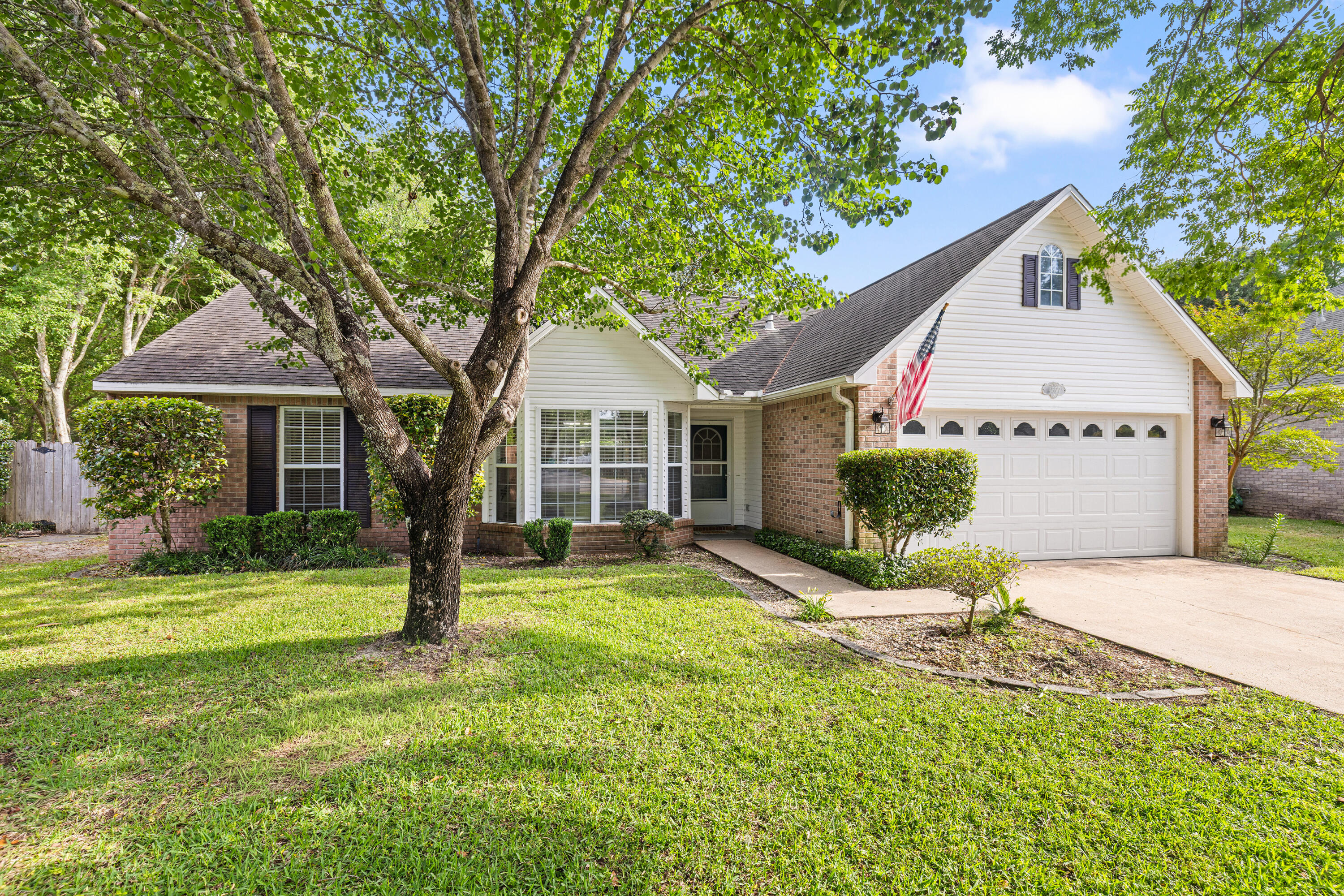 Welcome to this beautiful 4BR/3BA home tucked away on a quiet cul-de-sac in the gated community of Parkwood Estates. Inside, brand new LVP flooring and fresh neutral paint create a bright, updated feel from the moment you walk in. The split bedroom layout provides both privacy and functionality, while the spacious living areas are ideal for everyday living.  The kitchen flows seamlessly into the main living area and features a bright breakfast nook overlooking the backyard.  Master bedroom is conveniently located on the first floor, along with an additional bedroom and full bath.  A separate dining room and spacious living area, highlighted by corner gas fireplace, offer an inviting space for gathering and entertaining. Upstairs features two additonal bedrooms, a full bath, and a versatile landing area, perfect for a home office, study nook, play area or cozy sitting space.  Enjoy added privacy with reservation land bordering the side of the property. The spacious backyard is designed for outdoor enjoyment, featuring a large deck with pergola, string lighting, and a dedicated fire pit area, perfect for relaxing evenings or gathering with friends and family.  Fresh new sod is currently being installed, and the rear fence is being replaced, creating an even more inviting outdoor space. There's also plenty of space to add a pool, garden, or expanded living area. Major updates include a new Roof 2026 and updated electrical panel 2026. Ideally located within walking distance to Bluewater Bay Elementary School and just around the corner from a neighborhood park, plus convenient to shopping, dining, Destin's beautiful beaches and local amenities. Enjoy the Bluewater Bay lifestyle with nearby golf, tennis, pickleball, walking trails, and a full-service marina.  Convenient access to Eglin AFB, Duke Field, and Hurlbert Field. Experience the privacy, convenience, and lifestyle that make Parkwood Estates one of Niceville's most desirable gated communities.