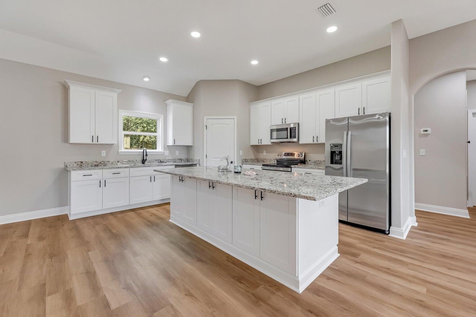 NEW CONSTRUCTION on 2.64 PRIVATE ACRES in Crestview with an Estimated October / November 2026 Completion!

Don't miss this incredible opportunity to own a brand-new home situated on a beautiful 2.64-acre homesite offering the perfect blend of privacy, space, and modern finishes. This thoughtfully designed 4-bedroom, 2-bathroom home features 2,316 square feet of living space with a desirable open-concept split floor plan that today's buyers love.

Quality finishes throughout include luxury vinyl plank flooring throughout the entire home (no carpet), granite countertops in the kitchen and both bathrooms, all-wood cabinetry, ceiling fans throughout, and a complete stainless steel appliance package, including the refrigerator, smooth-top range, microwave, and dishwasher.

The spacious living room boasts 10-foot ceilings and flows seamlessly into the impressive kitchen, complete with a massive 4' x 8' island, breakfast bar, corner pantry, and abundant cabinet and countertop space. Just off the kitchen, the elegant formal dining room features an 11-foot tray ceiling, creating the perfect setting for family gatherings and entertaining.

The private owner's suite offers a 10-foot tray ceiling and a spacious ensuite bath featuring double vanities, a large walk-in closet, separate water closet, linen closet, and walk-in shower.

On the opposite side of the home, you'll find three generously sized guest bedrooms and a full bathroom, providing privacy and comfort for family or visitors. Each bedroom is equipped with USB charging outlets for added convenience.

Additional features include an oversized two-car garage leading into a functional mudroom with built-in bench and a dedicated laundry room, creating an ideal everyday entry.

Outside, you'll enjoy covered front and rear porches, dimensional shingle roofing, and nearly three acres of land with a combination of cleared space and mature trees that provide a peaceful, private setting. There is ample room to build a workshop, pole barn, detached garage, RV or boat storage, additional outbuildings, or simply enjoy the wide-open space.

Estimated completion is October/November 2026. Depending on the stage of construction at the time of contract, buyers may have the opportunity to select certain colors and finishes.

Photos are of a similar home recently completed and are for illustration purposes only.

This is your chance to own a beautiful new construction home on acreage while enjoying the privacy of country living with the convenience of nearby shopping, schools, military bases, and the Emerald Coast. Schedule your showing today!