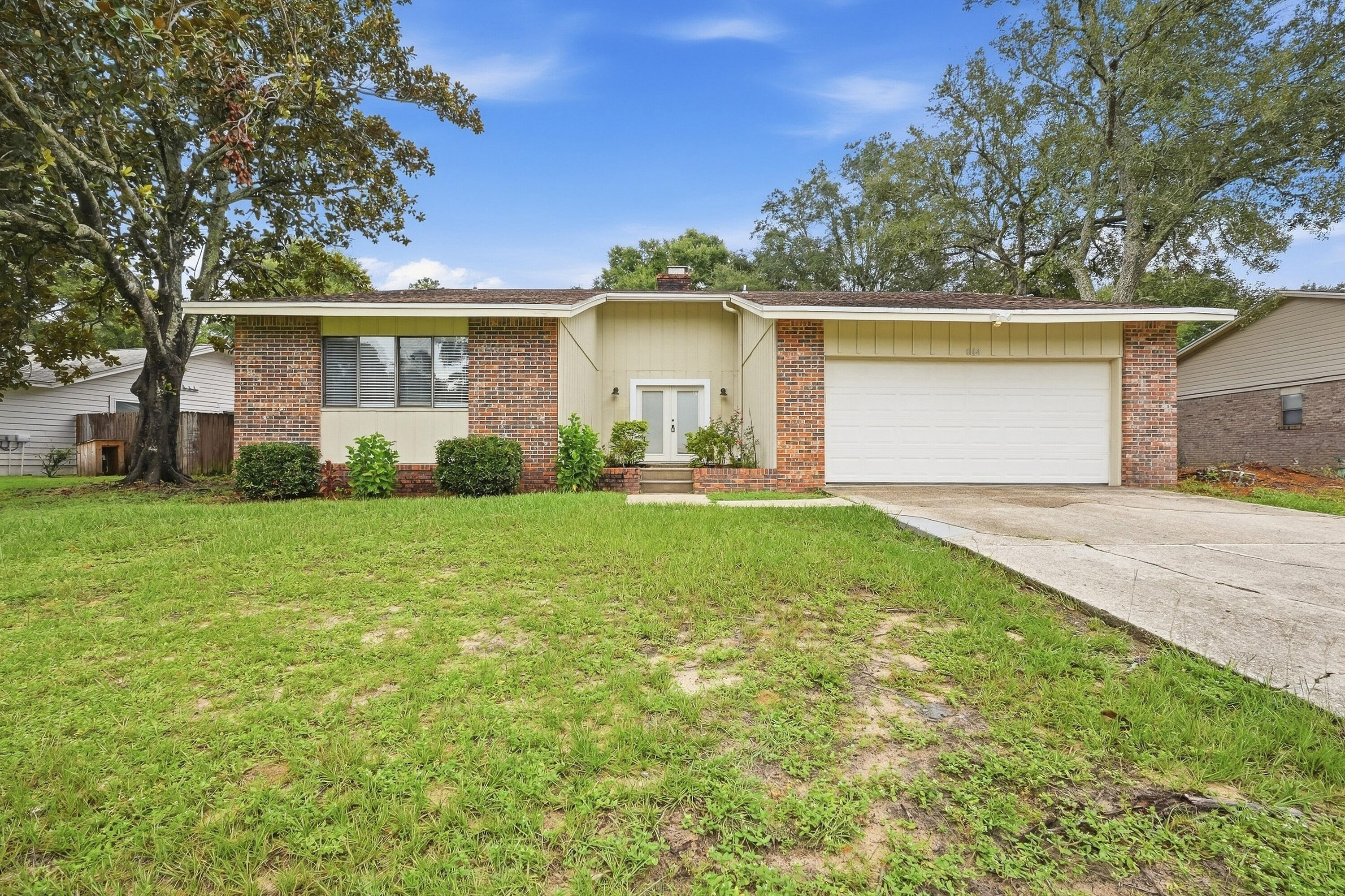 Welcome to this beautifully renovated home in the highly sought-after Bluewater Bay community, close to the Mid-Bay Bridge! This inviting 3-bedroom, 2-bathroom home offers a spacious split-bedroom floor plan, modern updates, and effortless Florida living.

Step inside to a bright, open-feeling interior featuring crisp white tile flooring throughout and modern window blinds. The spacious main living area is anchored by a central striking all-brick, white-painted fireplace, creating a warm and inviting focal point for relaxing or entertaining.

The updated kitchen combines style and functionality with stainless steel appliances and a fully tiled backsplash that adds a sleek, contemporary finish. Just beyond the main living spaces, is the spacious Florida room that provides an additional living space--perfect for entertaining or simply enjoying the beautiful Florida weather year-round.

Outside, the fully fenced backyard offers a private and peaceful setting surrounded by large, mature trees. There's plenty of room outdoors to play, garden, or simply unwind in your own backyard oasis.

Enjoy all that the Bluewater Bay lifestyle has to offer, including scenic hiking and biking trails, community pools, tennis and pickleball courts, golf, and a marina. Zoned for highly regarded Bluewater Bay schools and conveniently located near Eglin Air Force Base, shopping, dining, and the area's renowned white-sand beaches, this home places you close to everything while offering a comfortable place to call home.

Pets considered with application. Contact us today to schedule your showing!