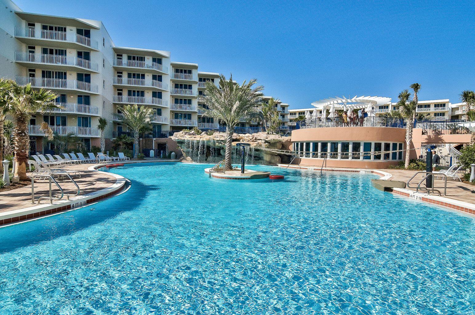 WATERSCAPE RESORT is Okaloosa Island's top family resort, and this unit is located in the eastside building. This unit conveys fully furnished and rental ready. The kitchen is equipped with stainless steel appliances, granite counter tops, and solid wood cabinetry. A new stackable washer/dryer is located in a storage space in the kitchen.  Both bedrooms have spacious ensuite bathrooms with garden tubs, double vanities, and separate showers. Tall glass doors open to the balcony.  A bunkroom provides a cozy and private spot for the kids.  Amenities include: 490 feet of beachfront, two hot tubs, fitness center, gas grills, large conference room, game room, various pool features, tropical pavilion, covered parking and more!  Buy a piece of paradise!