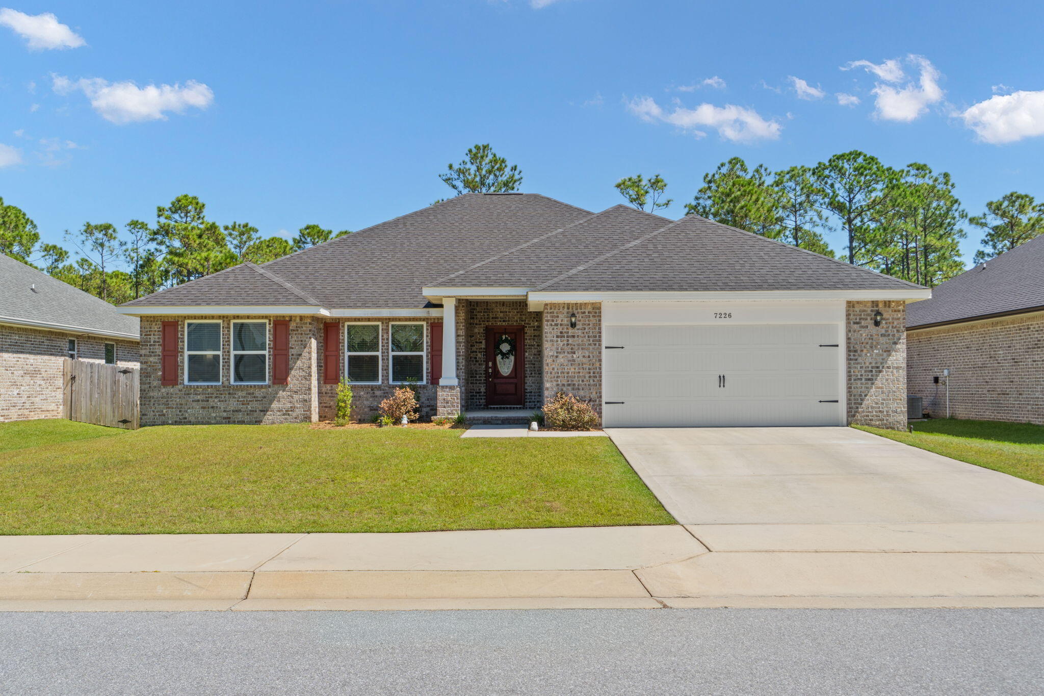 Tucked away on a quiet dead-end street with a cul-de-sac in Navarre's Secret Isle community, this beautifully maintained 2023-built home offers 4 bedrooms, 2 bathrooms, a spacious split floor plan, and a backyard designed for enjoying Florida living year-round. The neighborhood offers a tucked-away, natural setting while still providing convenient access to Hwy 87, shopping, dining, area schools, Navarre Beach, and Hurlburt Field. Inside, the open-concept kitchen and living area creates a bright and welcoming space for everyday living and entertaining. LVP flooring flows throughout the main living areas and bathrooms, complemented by upgraded lighting and thoughtful finishes. The kitchen features granite countertops, stainless steel appliances, and upgraded cabinetry with crown molding. The spacious owner's suite features a tray ceiling, garden tub with tiled surround, granite countertops, and separate tiled walk-in shower with glass door. The generous walk-in closet provides direct access to the laundry room, which is also conveniently accessible from the hallway. Outside, enjoy a screened-in back patio, extended paver patio, and fully fenced backyard with plenty of room to relax, grill, entertain, or enjoy the outdoors. Less than 20 minutes from Navarre Beach and 25-30 minutes from Hurlburt Field, this home offers newer construction, upgraded finishes, functional design, and a fantastic Navarre location.