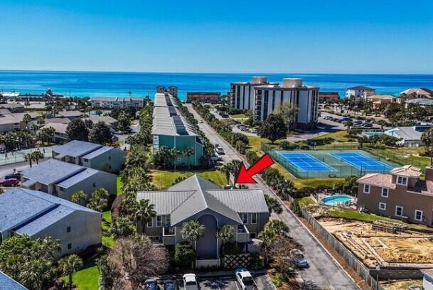 This affordable low-maintenance coastal gem sits directly across the street from the community Deeded Beach Access. Two master suites with private ensuite bathrooms are located on the second floor.  The first floor is spacious with tiled flooring and a glistening white kitchen with stainless appliances.  Enjoy summers outside on the private fenced courtyard where there is a BBQ grill and large closet to store all your beach gear. Don't worry about bringing sand inside - just use the outdoor shower.  For rough sea days, enjoy the convenience of a community pool.  Move in ready - all furnishings convey with the sale, and this home was recently added to a short-term rental program.
https://www.destinluxurybeachrentals.com/1045969/  Turn-key and ready for you!
