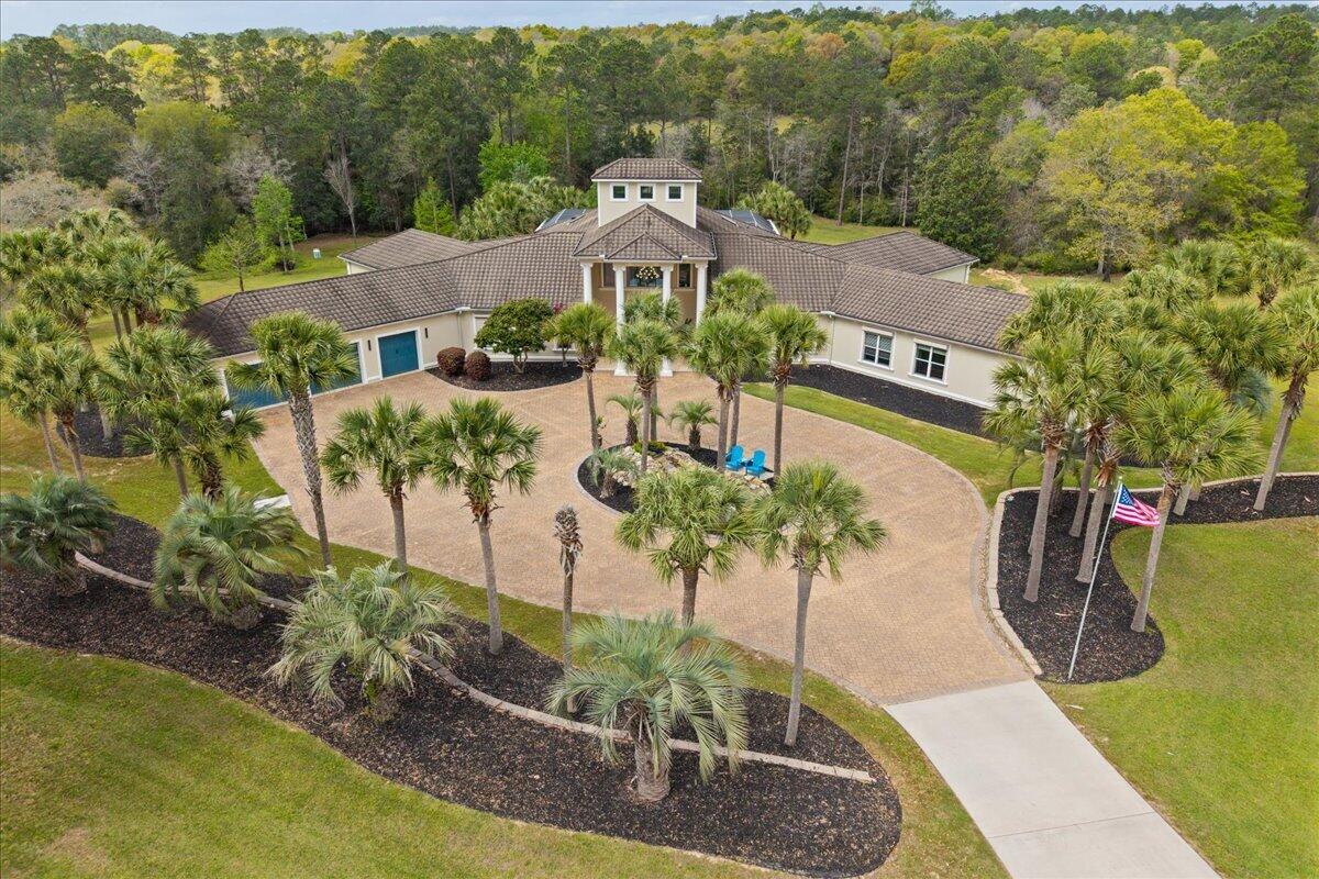 Experience the pinnacle of luxury ranch living on this breathtaking 60-acre equestrian estate, where world-class horse facilities meet an exceptionally built custom residence. Designed for both functionality and refined living, this property offers a rare opportunity to own a fully equipped horse ranch without compromising on modern comfort and sophistication.

                    GO TO MORE!!!!! Equestrian enthusiasts will appreciate the thoughtfully designed facilities, including a 10-stall stable, professional riding arena, dedicated cool-down ring, and a fully equipped horse washing station. Four white vinyl-fenced paddocks provide both safety and aesthetic appeal, while a pole barn and chicken coop add versatility for a true working ranch. The land itself is equally impressive, featuring a stocked pond and a stunning year-round creek with a rare white sandy bottom--creating a serene and picturesque environment.

Additional infrastructure includes a 40x60 metal building/shop with a 15x50 heated and cooled finished section, ideal for a workshop, office, or hobby space, as well as a convenient RV pad. Fenced fruit trees offer protection from wildlife while adding a sustainable living element to the property.

A gated concrete driveway leads to the estate's crown jewel--a superior construction custom home built with ICF (Insulated Concrete Form) for maximum durability, energy efficiency, and storm resistance. The residence boasts an impressive 10,160 square feet under roof, with 7,169 square feet of heated and cooled living space.

Inside, the home is designed for both everyday living and grand entertaining. Featuring 5 spacious bedrooms, 4 with their own private bathroom, plus 2 additional half baths, the layout offers privacy and convenience throughout. A dedicated office, private movie theater, and a state-of-the-art smart home system elevate the living experience.

The chef's kitchen is a true showpiece, complete with commercial-grade appliances, quartz countertops, a large breakfast area, separate formal dining space, and a walk-in pantry with custom shelving. An oversized wood-burning fireplace anchors the main living area, while a dedicated bar and wine storage area create the perfect setting for entertaining.

Each bedroom includes custom-designed closets, and the home continues to impress with an expansive 1,101-square-foot 3-car garage featuring polyaspartic flooring and foam insulation. A backup natural gas generator ensures peace of mind and uninterrupted comfort.

Step outside to your private resort-style retreat, where a screened-in pool, hot tub, and fully equipped outdoor kitchen create the ultimate entertaining space--perfect for enjoying quiet evenings or hosting large gatherings.

A separate 1,800-square-foot guest home with 2 bedrooms and 2 bathrooms offers incredible flexibility for ranch hands, extended family, or rental income potential.

This exceptional property seamlessly blends luxury, functionality, and natural beauty--ideal for a working horse ranch, private estate, or multi-use investment opportunity.