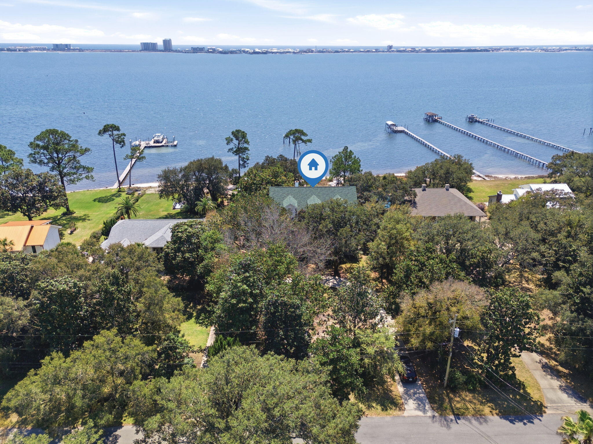 First time ever on the market -- a rare waterfront opportunity on Pompano!

Situated on an incredible 3/4 of an acre waterfront lot with its own white sandy beach, this property offers the kind of setting that is becoming nearly impossible to find. With breathtaking water views, an inground pool, and expansive outdoor living spaces, this home is ready for its next chapter.

The home features a newer roof and brand-new windows currently on order and scheduled for installation within the next two weeks, providing peace of mind for the future owner.

Inside, you'll find an abundance of natural light pouring through the home along with a kitchen that offers plenty of cabinet space for storage and functionality. Some areas feature hardwood flooring that could easily be refinished to bring back its original charm.
The main floor layout includes the primary bedroom, dining room, breakfast nook, living room, and laundry room, creating convenient everyday living. Downstairs, you'll find additional bedrooms along with another full bathroom that offers direct access to the pool area, making it ideal for entertaining or guests.

The oversized front porches create a welcoming entrance and provide the perfect place to relax and take in the peaceful waterfront setting.

For those needing space for vehicles, hobbies, or storage, the property includes a true oversized three-car side-entry garage, offering more room than a standard garage.

With no HOA, you'll enjoy the flexibility to bring your boat, camper, or recreational toys home with ease.
This property has incredible potential and is ready for your personal renovation and modern design vision. Whether you're looking to create your dream waterfront residence, a vacation getaway, or a potential Airbnb investment, the possibilities here are endless.

Aside from the upcoming window installation, the home will be sold as-is.
Private tours are welcome, and open house events will be announced soon.
Don't miss this rare opportunity to own a large waterfront property with sandy beach frontage on Pompano.