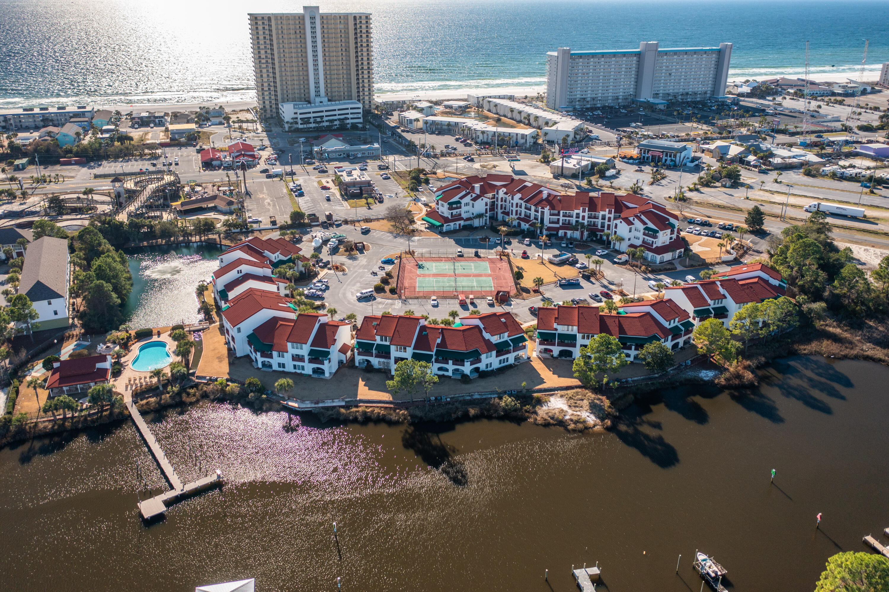 This bright and charming 623 sq. ft. studio condo has been freshly painted and features refreshed bathroom and kitchen, along with beautiful laminate wood floors throughout. Located on the second floor of the gated, European-inspired Inn at St. Thomas Square, this unit offers both elevator and stair access for your convenience.
Enjoy the ultimate beachside lifestyle with public beach access just steps away, and the Grand Lagoon right at your doorstep, perfect for boating, kayaking, or relaxing by the water.
The community offers an array of amenities, including a sparkling pool, tennis and pickleball courts, BBQ area with seating, sauna, shuffleboard, firepit area, and boat dock. Dock space is available on a first-come, first-served basis.