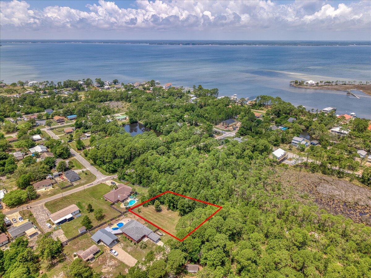 Build your dream home on this cleared corner lot ideally located just off Innerarity Road! Tucked into a quiet, peaceful setting, the property offers a private feel with surrounding trees providing a natural buffer while still being ready for immediate construction. With no HOA, you'll enjoy the freedom to design and build without restrictive covenants. Enjoy the best of coastal convenience with this well positioned lot, located just minutes from local's favorite Hub Stacey's, nearby beach accesses, Big Lagoon State Park, Publix, and Perdido Bay Golf Club, all within a 10-minute drive. Whether you're looking to build a primary residence, second home, or investment property, this property offers an ideal location with easy access to both recreation and everyday amenities!