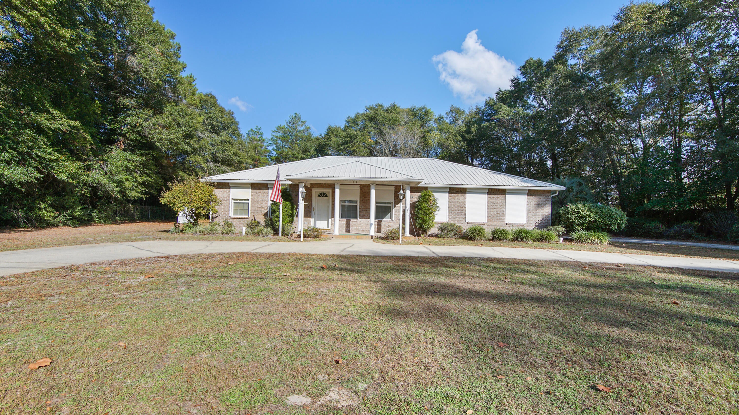 This one offers far more than what looks simple driving by. The sellers built it like they were preparing for the next century of Florida weather. If you want a low-maintenance snowbird spot or a retiree-friendly fortress you can lock and leave without a second thought, this one checks the boxes. The solid brick home features 2 bedrooms, 2.5 baths, and a 2 car attached garage finished in easy-care tile and vinyl (yes, even the oversized garage is tiled). The kitchen is oversized, the interior is spotless, and yes, it's ready for your personal touch, which is Realtor-code for ''the bones are great, bring your imagination.'' Out back you'll find an 18x45 RV cover with full hookup, plus an attached storage building that's already plumbed for a sink and commode. The added separate worksho with with a roll-up door and built-in shelving doesn't disappoint. So if you have tools, hobbies, a need to tinker or simply need extra on-site and easy to access storage, you're covered. Convert one of these buildings into a tiny home if you want extra living space or a long-term guest or rental setup. Safety features here are next-level:
Steel-cabled tie-downs on porches and buildings, steel rods on every window, hurricane shutters, and an authentic safe room that's even equipped with an escape hatch. You'll find 2 HVAC units, including a dedicated system just for the master suite. The property has city drinking water and a well for irrigation, which is a small but mighty win when the water bill rolls around. Conveniently accessed from 2 streets - both front and rear. Located less than 5 minutes to downtown DeFuniak Springs and 30 minutes to the sugar white sands. The seller is also open to owner financing with acceptable terms and a vetted buyer, which makes this opportunity even sweeter. If you want something strong, simple, and set up for an easy life in the FL panhandle, come see this one in person. It might surprise you.